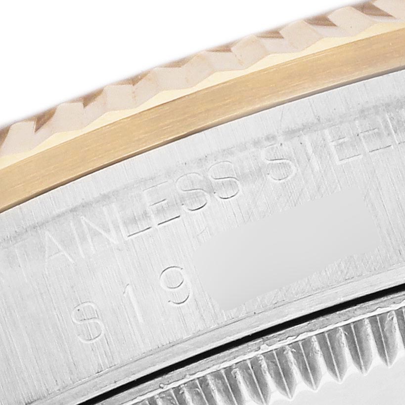 The image shows a close-up of the side of a Rolex Mid-Size 68273 Women's Steel and Gold (two tone) White Dial 68273 Women's Steel and Gold (two tone) White Dial watch, featuring the textured bezel and stainless steel case.