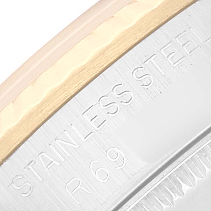 This image shows a close-up of the bezel and case side of a Rolex Mid-Size 68273 Women's Steel and Gold (two tone) Champagne Dial 68273 Women's Steel and Gold (two tone) Champagne Dial model, featuring "stainless steel" engraving.