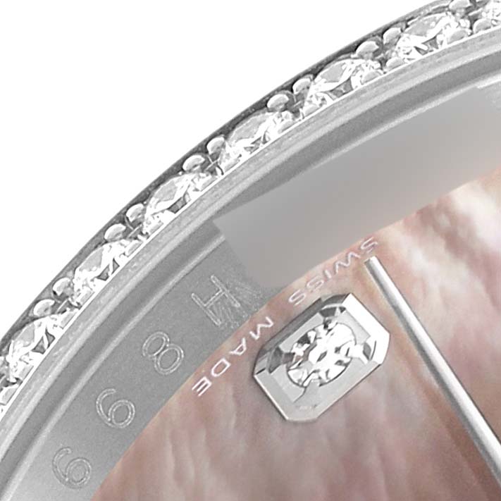 This close-up image of a Rolex Datejust 116244 Men's Stainless Steel Mother of Pearl Dial 116244 Men's Stainless Steel Mother of Pearl Dial watch shows part of the bejeweled bezel and the "Swiss Made" marking.