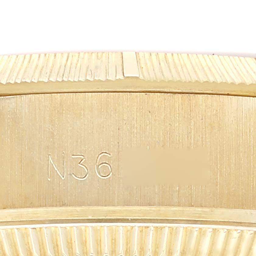 This image shows an engraved section of the bezel and case side of a Rolex President 69278 Women
s Yellow Gold Champagne Dial 69278 Women
s Yellow Gold Champagne Dial watch.