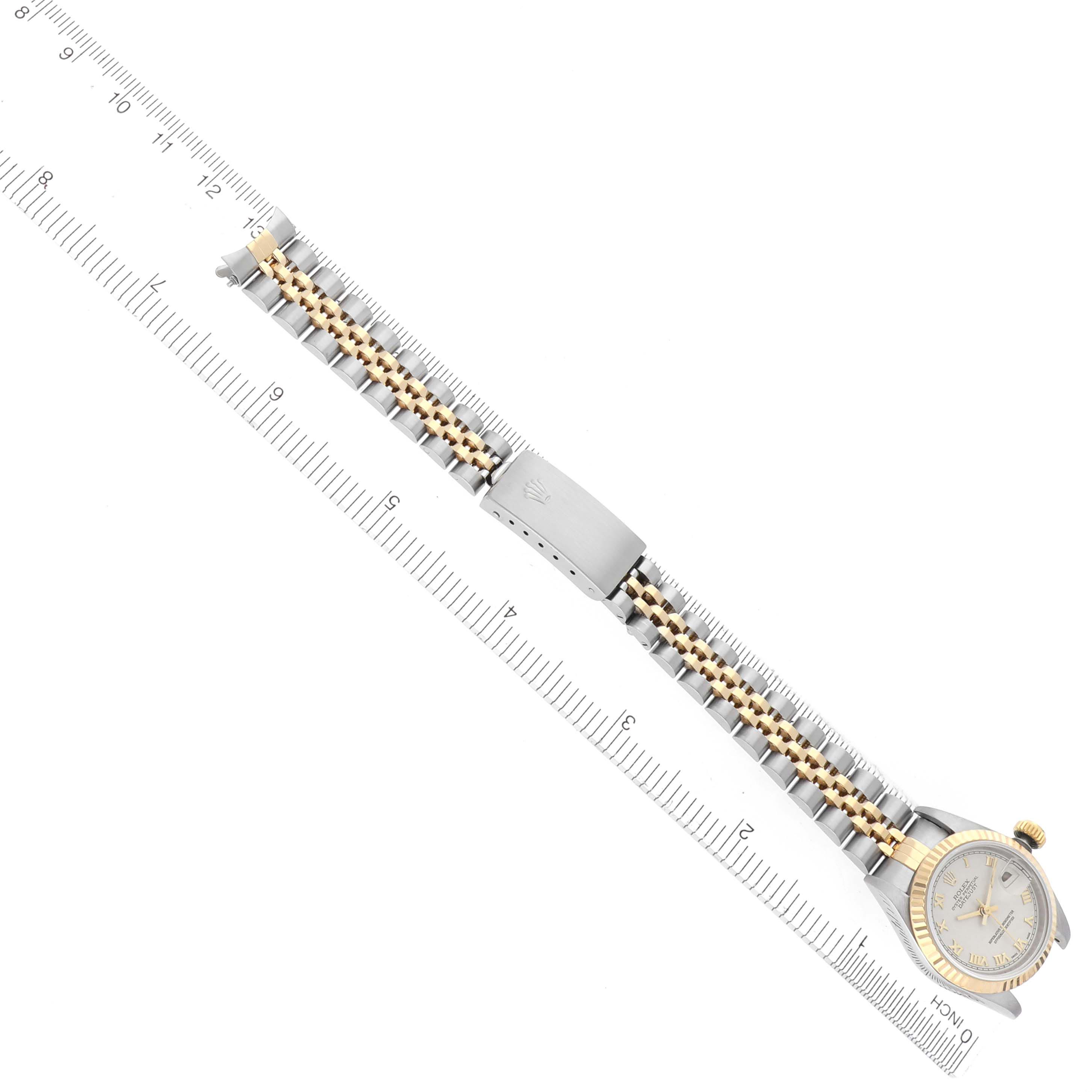 The Rolex Datejust 69173 Women's Steel and Gold (two tone) Beige Dial 69173 Women's Steel and Gold (two tone) Beige Dial watch is shown from an overhead angle, highlighting the entire bracelet, clasp, and face.