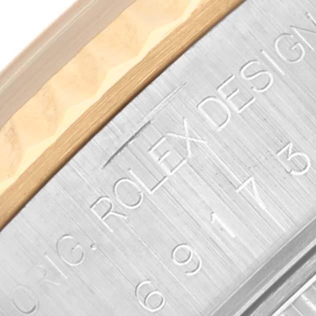 The image shows a close-up of the Rolex Datejust 69173 Women's Steel and Gold (two tone) Beige Dial 69173 Women's Steel and Gold (two tone) Beige Dial watch's case side, with engraved markings visible.