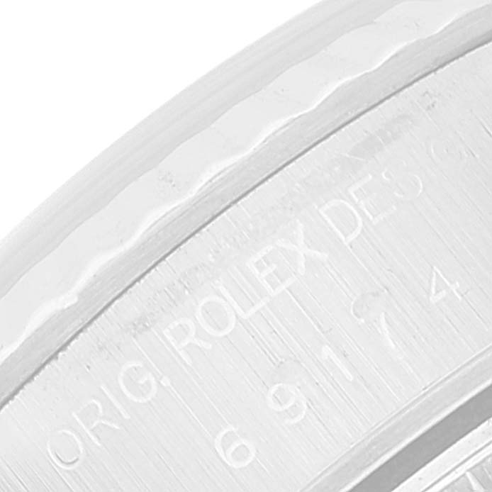 The image shows a close-up of the engraving on the side of the bezel of a Rolex Datejust 69174 Women's Stainless Steel Blue Dial 69174 Women's Stainless Steel Blue Dial watch.