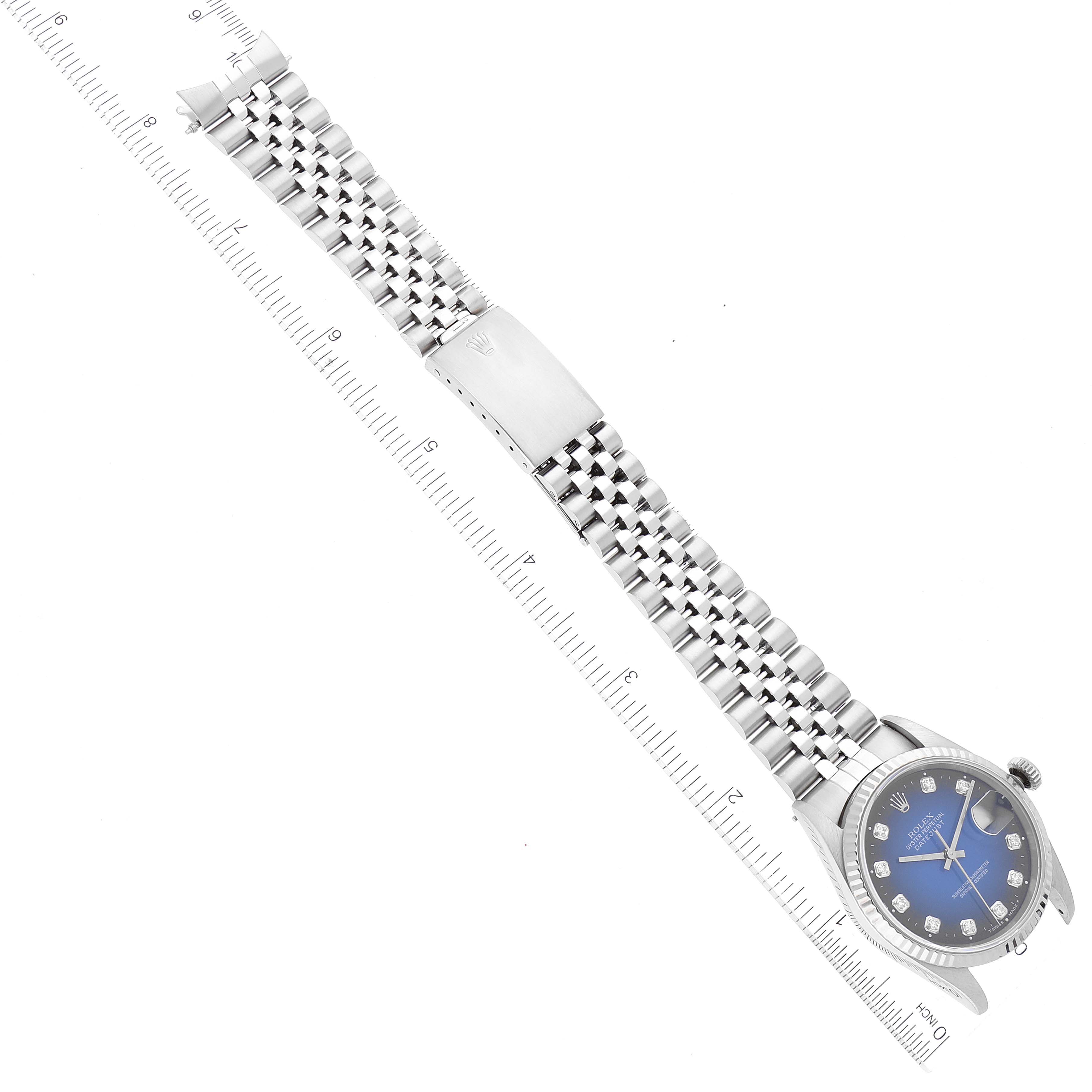 The image shows a Rolex Datejust 16234 Men's Stainless Steel Blue Dial 16234 Men's Stainless Steel Blue Dial watch laid flat with its bracelet and clasp visible, aligned with a ruler for scale.