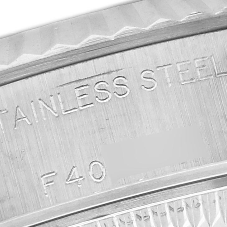 The image shows a close-up of the engraved stainless steel case back of a Rolex Datejust 79174 Women's Stainless Steel Pink Dial 79174 Women's Stainless Steel Pink Dial watch.