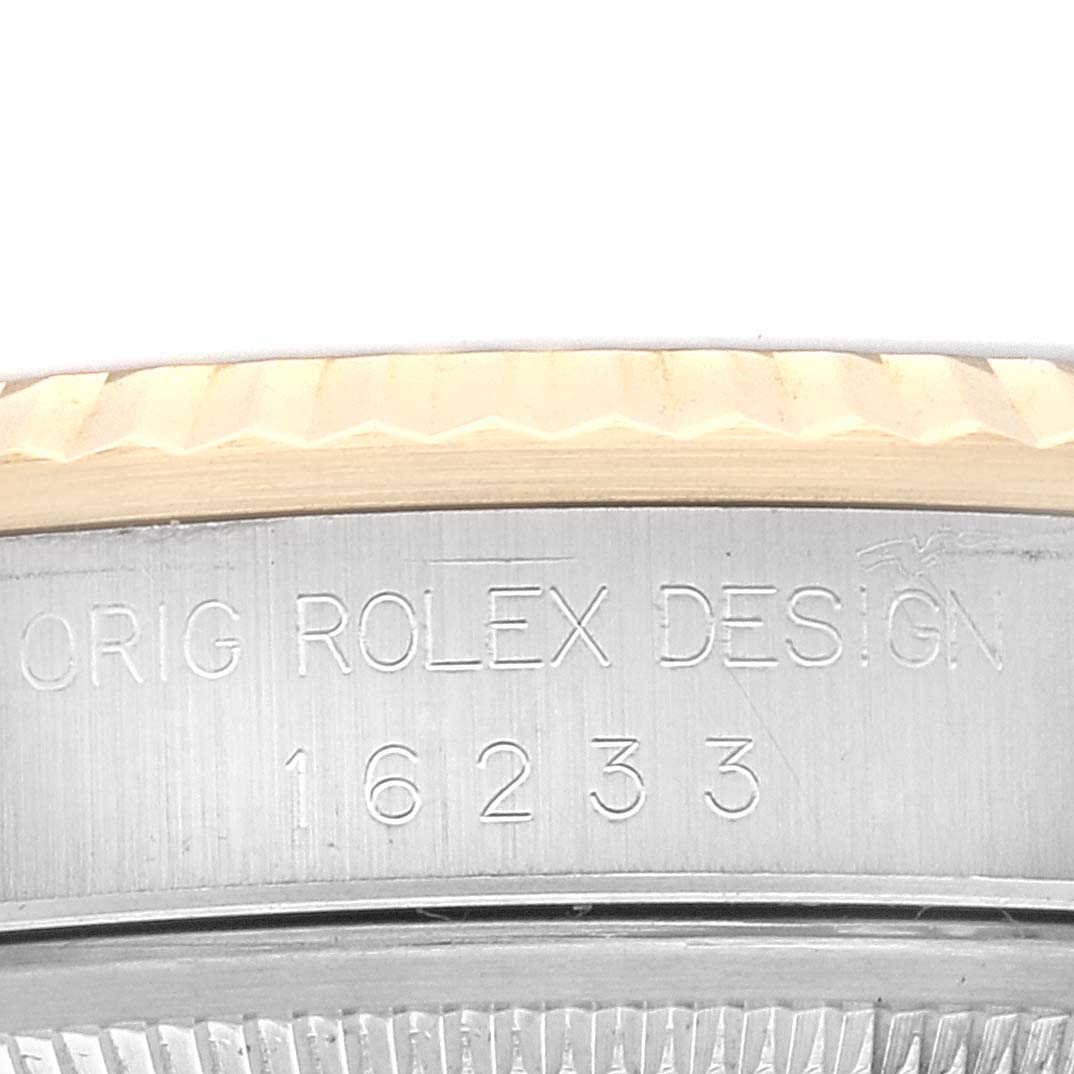 The image shows a partial view of the case side of a Rolex Datejust 16233 Men's Steel and Gold (two tone) Blue Dial 16233 Men's Steel and Gold (two tone) Blue Dial watch, with engraving displaying "ORIG ROLEX DESIGN 16233."