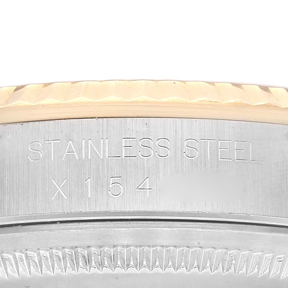 This image shows a close-up view of the Rolex Datejust 16233 Men's Steel and Gold (two tone) Blue Dial 16233 Men's Steel and Gold (two tone) Blue Dial model's stainless steel case part, displaying the text "STAINLESS STEEL" and "X154".