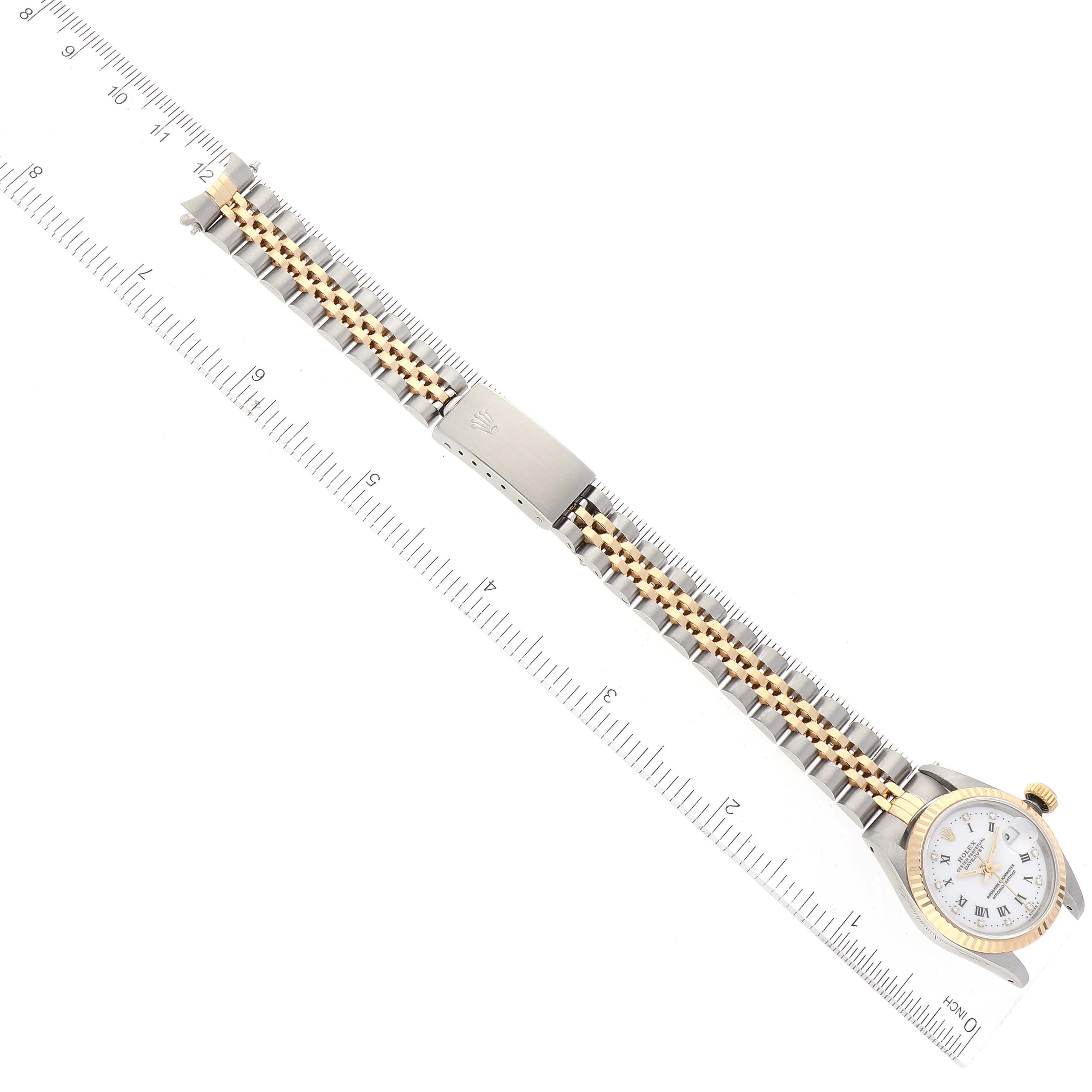 The image shows a Rolex Datejust 69173 Women's Steel and Gold (two tone) White Dial 69173 Women's Steel and Gold (two tone) White Dial watch from a top-down angle, focusing on the bracelet, clasp, case, crown, and partial dial.