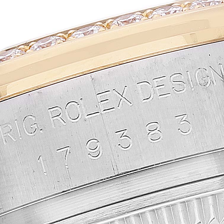 This close-up image shows the engraved serial number and part of the bezel of a Rolex Datejust 179383 Women's Steel and Gold (two tone) Mother of Pearl Dial 179383 Women's Steel and Gold (two tone) Mother of Pearl Dial.
