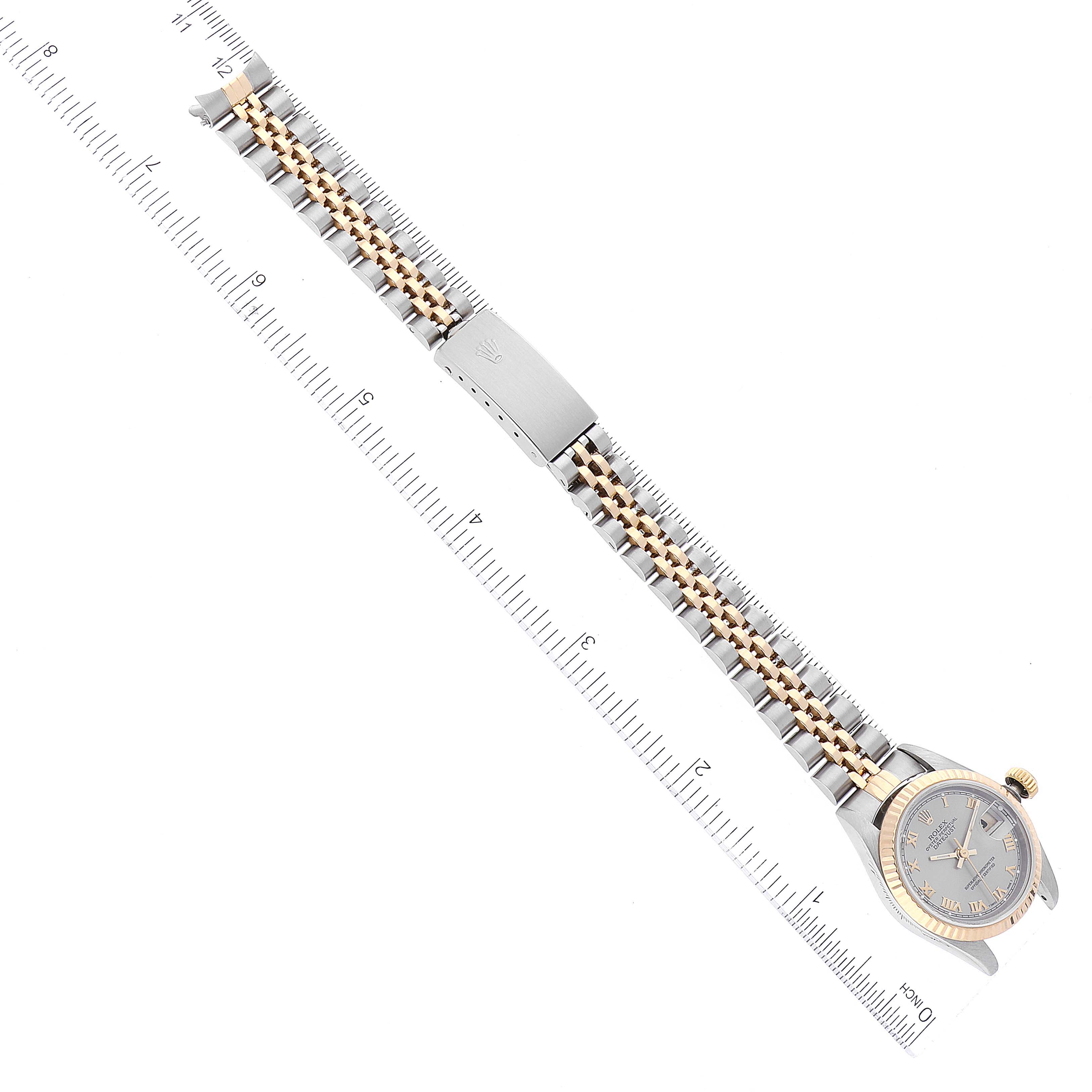 This image shows a Rolex Datejust 69173 Women's Steel and Gold (two tone) Grey Dial 69173 Women's Steel and Gold (two tone) Grey Dial watch lying flat, fully extended, with a ruler measuring its length.