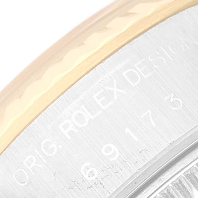 This image shows a close-up of the edge of the dial and case of a Rolex Datejust 69173 Women's Steel and Gold (two tone) Grey Dial 69173 Women's Steel and Gold (two tone) Grey Dial watch, highlighting the engraved text on the case.