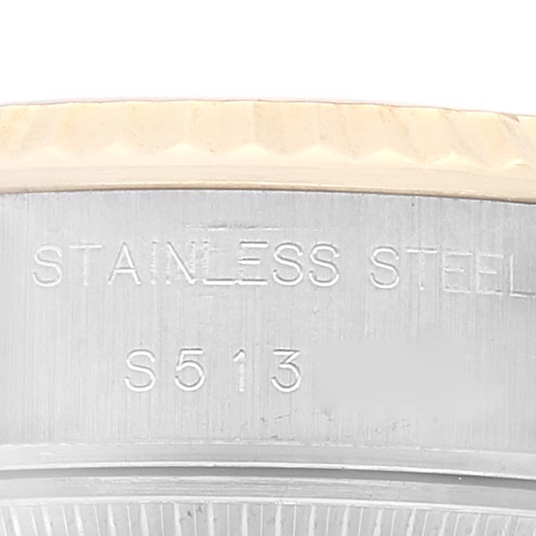 This close-up image of the Rolex Datejust 69173 Women's Steel and Gold (two tone) White Dial 69173 Women's Steel and Gold (two tone) White Dial shows part of the stainless steel casing with serial number engraving.