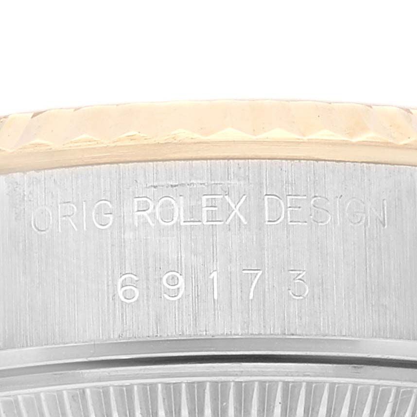 This image shows a close-up of the side of a Rolex Datejust 69173 Women's Steel and Gold (two tone) White Dial 69173 Women's Steel and Gold (two tone) White Dial watch, focusing on the engraved serial number and "ORIG ROLEX DESIGN" text.