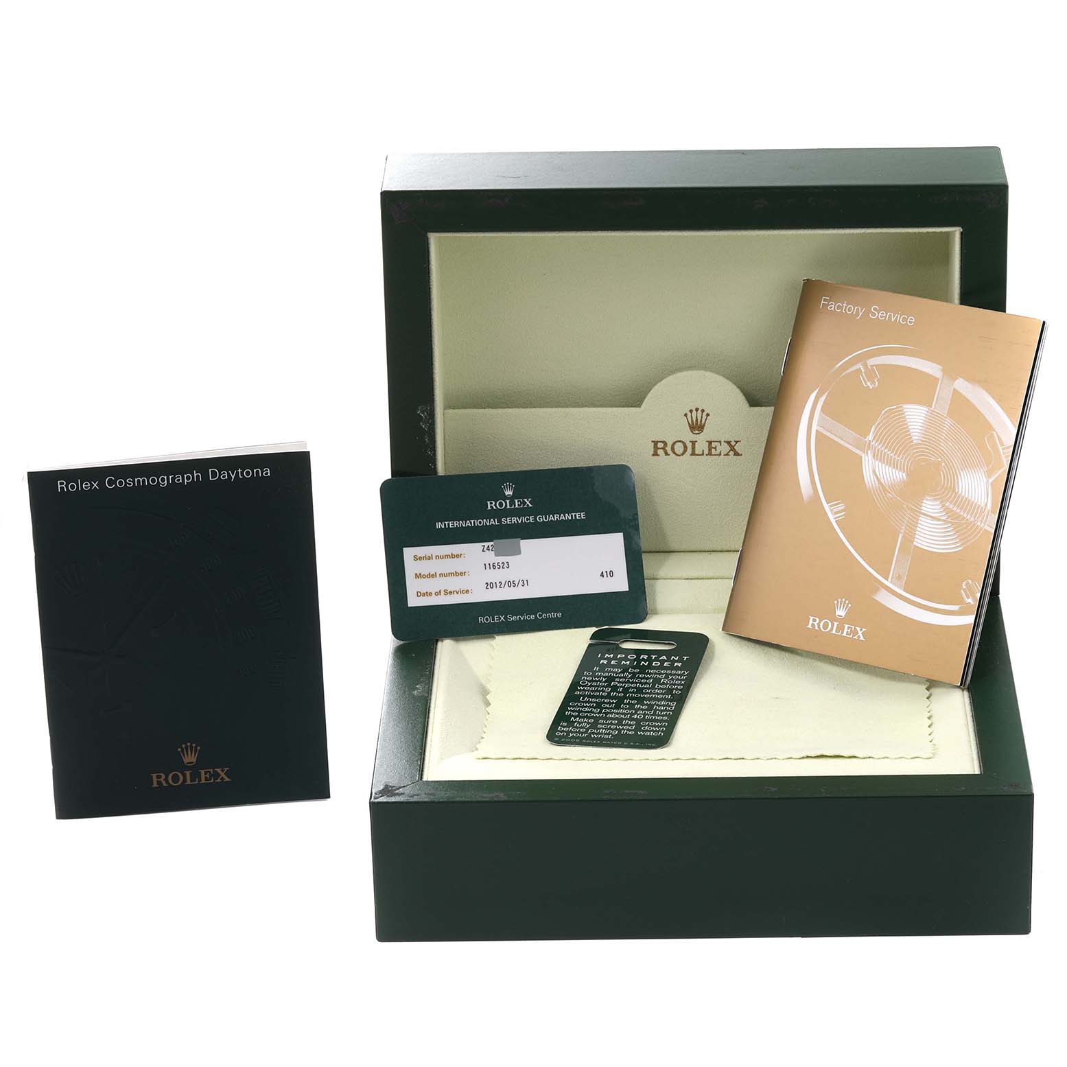 The image shows the packaging and accessories for a Rolex Daytona 116523 Men
s Steel and Gold (two tone) Black Dial 116523 Men
s Steel and Gold (two tone) Black Dial, including booklets, a warranty card, and the watch box.