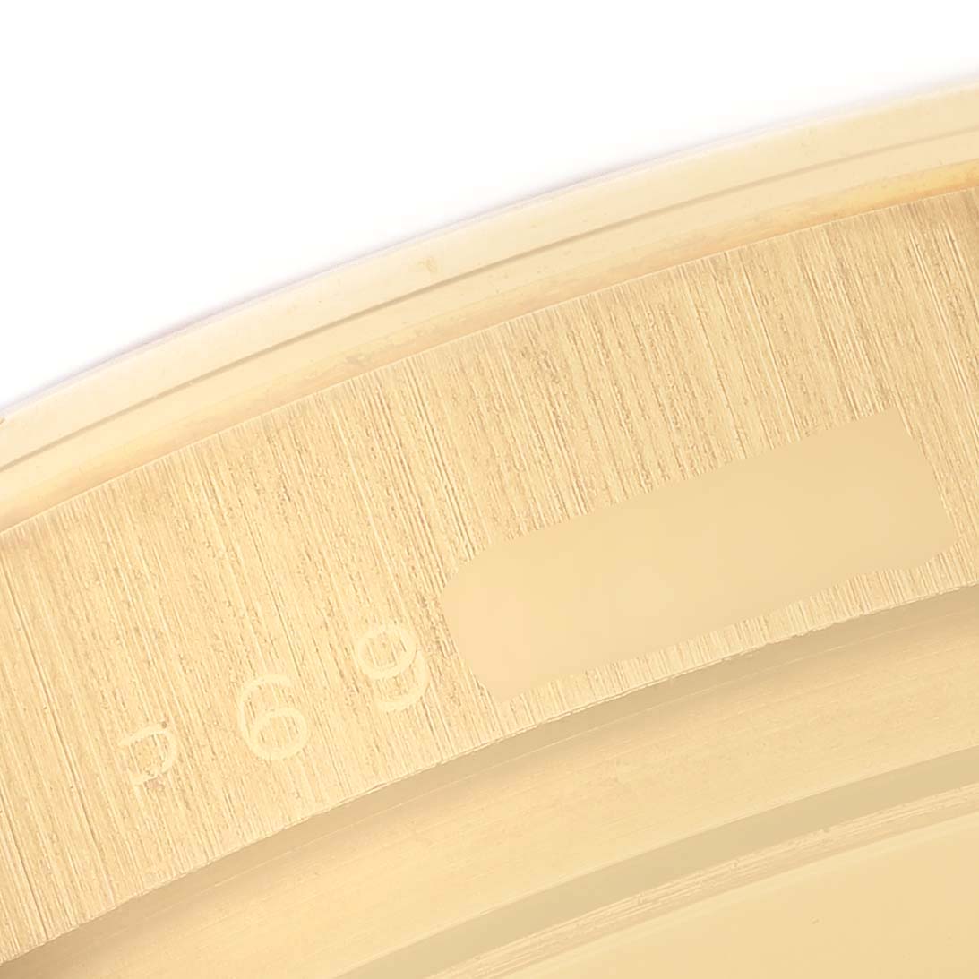 This image shows a close-up of the serial number engraved on the case of a Rolex Daytona 116528 Men's Yellow Gold Champagne Dial 116528 Men's Yellow Gold Champagne Dial watch.