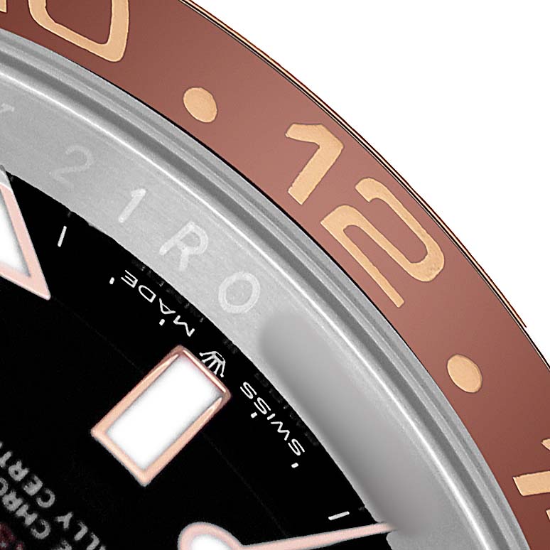 The image shows a close-up of the bezel and dial edge of a Rolex GMT-Master 126711 Men's Steel and Gold (two tone) Black Dial, highlighting hour markers and bezel numbers.