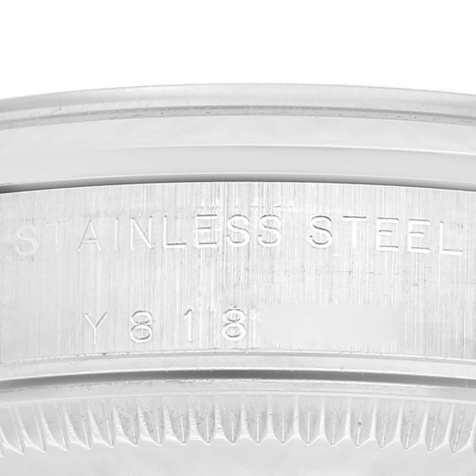 This image shows a close-up of the stainless steel casing with serial number engraving on a Rolex Mid-Size 77080 Women's Stainless Steel Pink Dial 77080 Women's Stainless Steel Pink Dial model watch.
