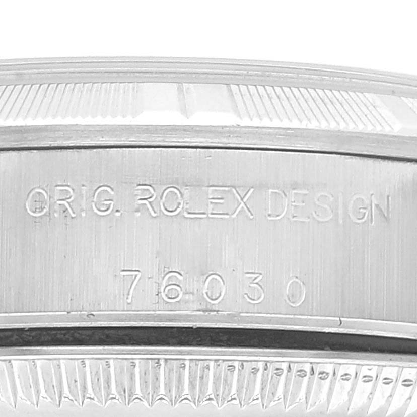This image shows a close-up of the engraved case back of a Rolex Oyster Perpetual 76030 Women's Stainless Steel Silver Dial 76030 Women's Stainless Steel Silver Dial model with the design number 76030.