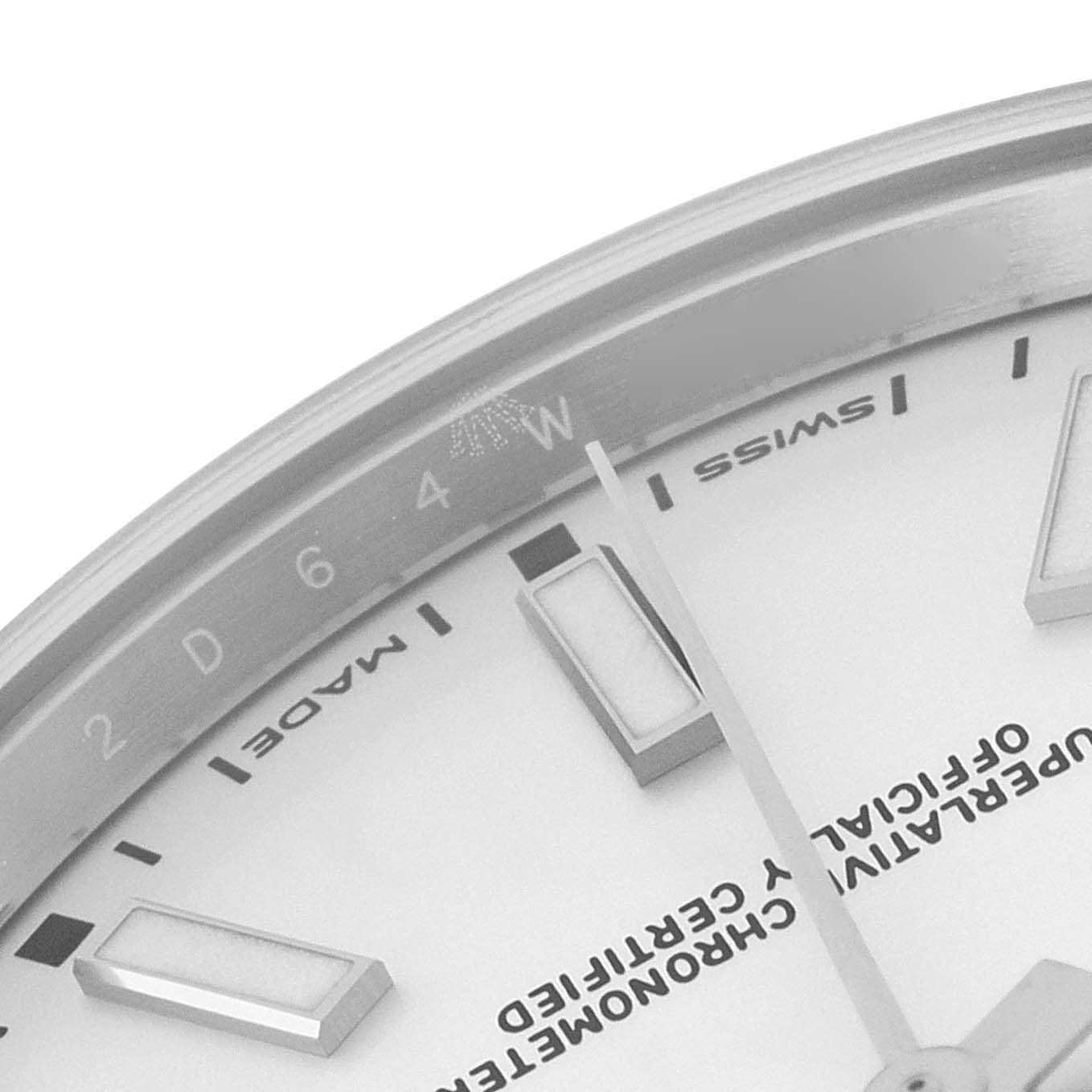 The image shows a close-up of the dial and part of the bezel of a Rolex Oyster Perpetual 114300 Men's Stainless Steel Silver Dial 114300 Men's Stainless Steel Silver Dial watch.