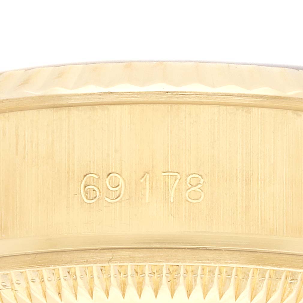 The image shows the side view of the Rolex President 69178 Women
s Yellow Gold Champagne Dial 69178 Women
s Yellow Gold Champagne Dial model, focusing on the engraved reference number.