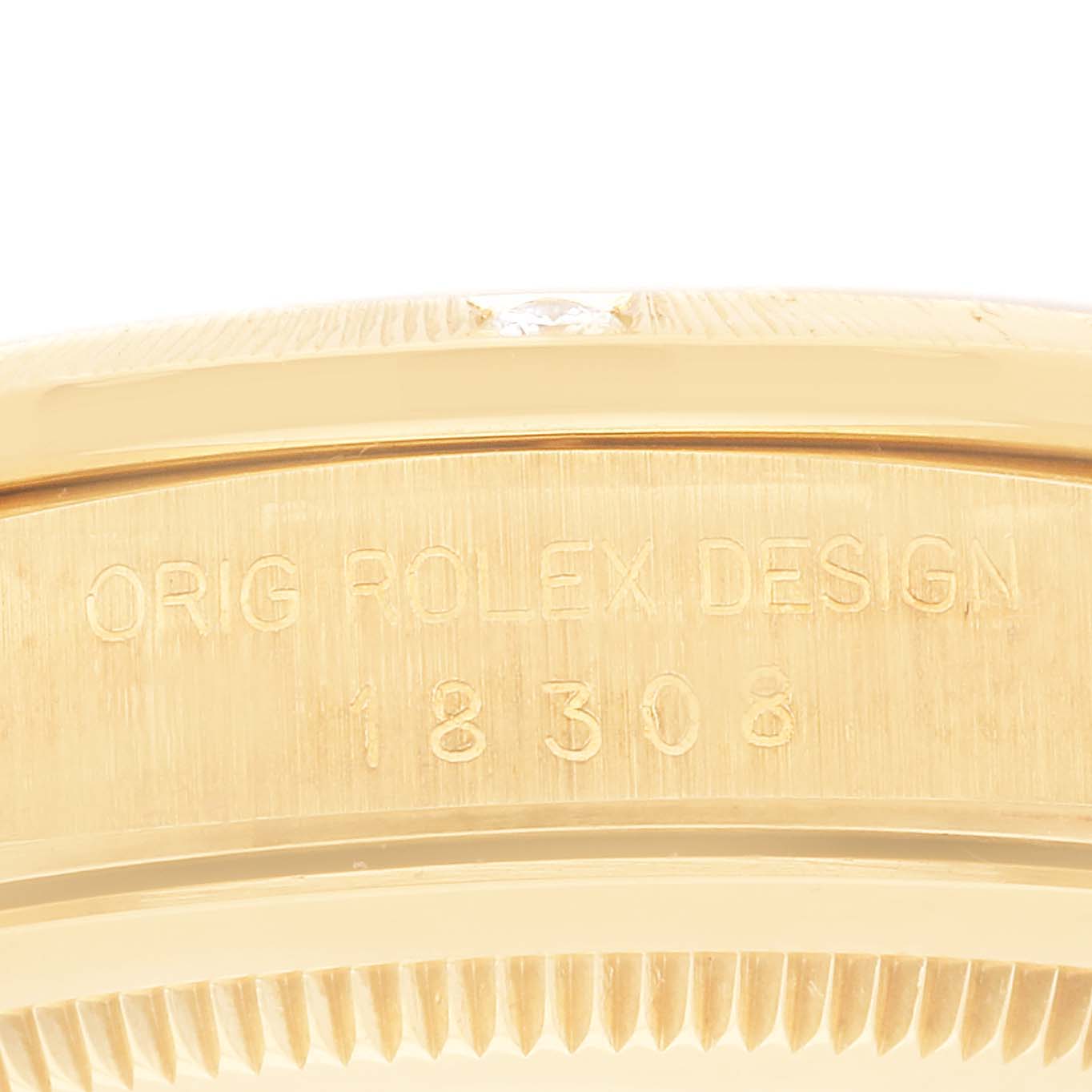 The image shows a close-up of the side of the gold Rolex President 18308 Men's Yellow Gold Black Dial 18308 Men's Yellow Gold Black Dial model watch, highlighting the engraving and case details.