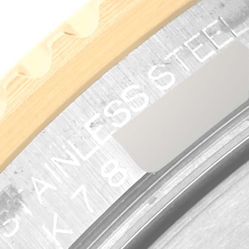 The image shows a close-up of the side of a Rolex Submariner 16613 Men's Steel and Gold (two tone) Blue Dial 16613 Men's Steel and Gold (two tone) Blue Dial watch, highlighting the edge of the case and bezel, with "STAINLESS STEEL" engraving.