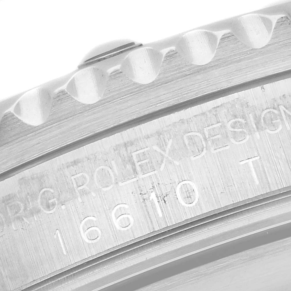 The image shows a close-up of the side of the bezel and case of a Rolex Submariner 16610 Men
s Stainless Steel Black Dial 16610 Men
s Stainless Steel Black Dial watch, highlighting the model number and engravings.
