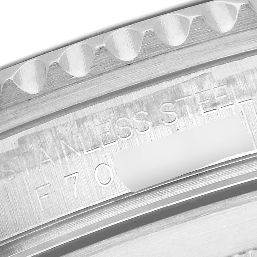 The image shows a close-up of the stainless steel casing and the engraved serial number of a Rolex Submariner 16610 Men
s Stainless Steel Black Dial 16610 Men
s Stainless Steel Black Dial watch.