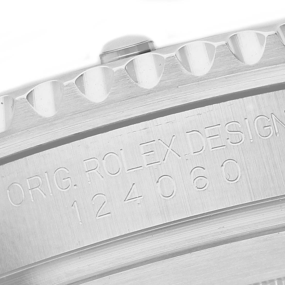 The image shows the side view of the Rolex Submariner 124060 Men's Stainless Steel Black Dial's case, featuring engraved text and part of the knurled bezel.