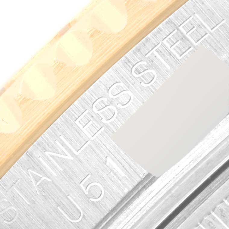 This close-up image shows part of the bezel and caseback of a Rolex Yacht-Master 68623 Men's Steel and Gold (two tone) Blue Dial 68623 Men's Steel and Gold (two tone) Blue Dial watch, highlighting the "STAINLESS STEEL" engraving.