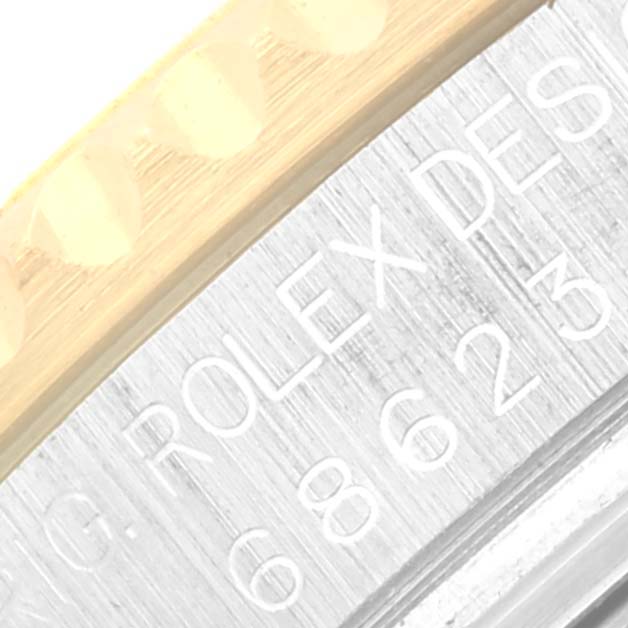 This close-up shows the engraved bezel and part of the case of the Rolex Yacht-Master 68623 Men's Steel and Gold (two tone) Blue Dial 68623 Men's Steel and Gold (two tone) Blue Dial watch.