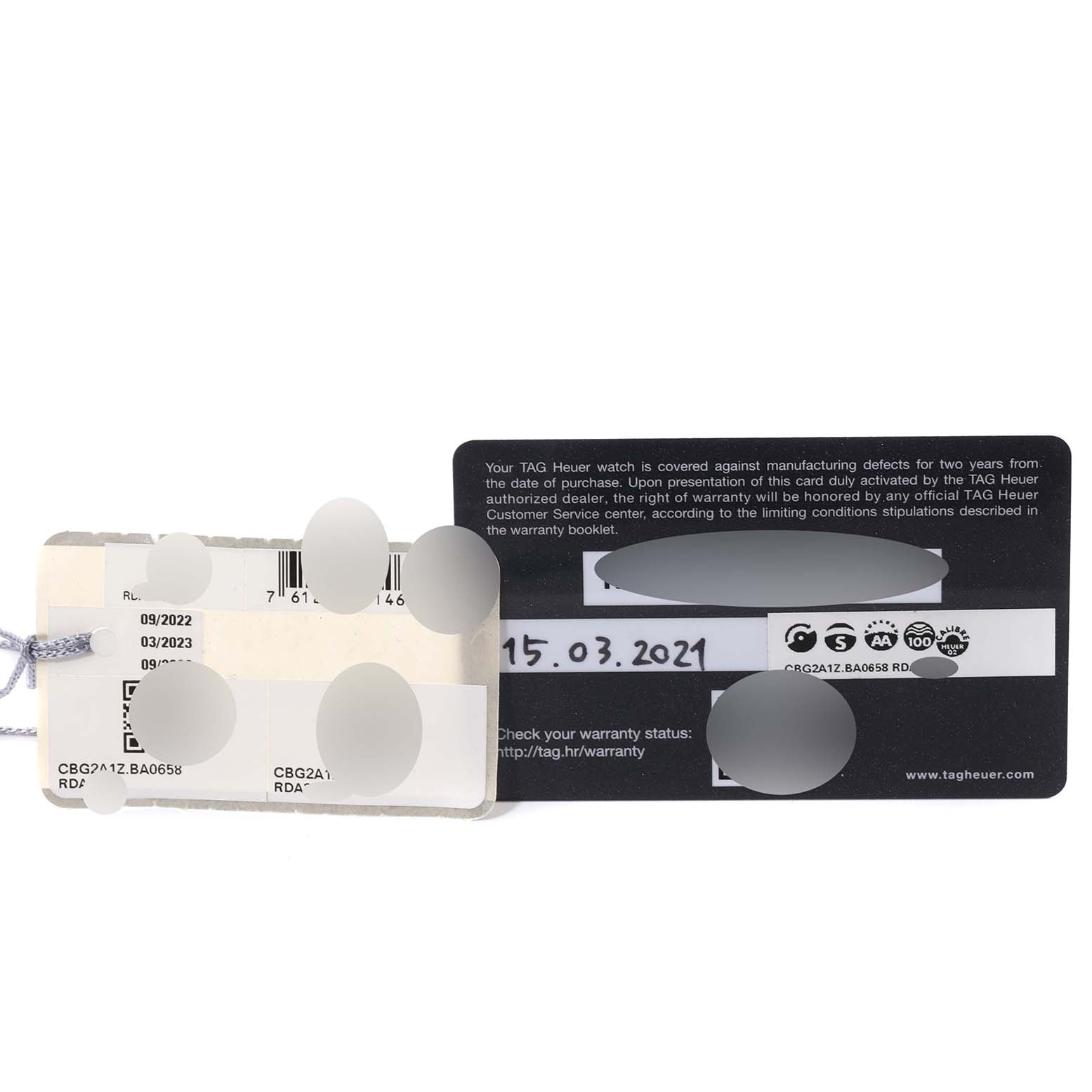 The image shows the warranty card and tags for a Tag Heuer Carrera CBG2A1Z.BA0658 Men
s Stainless Steel Black Dial CBG2A1Z.BA0658 Men
s Stainless Steel Black Dial model watch.
