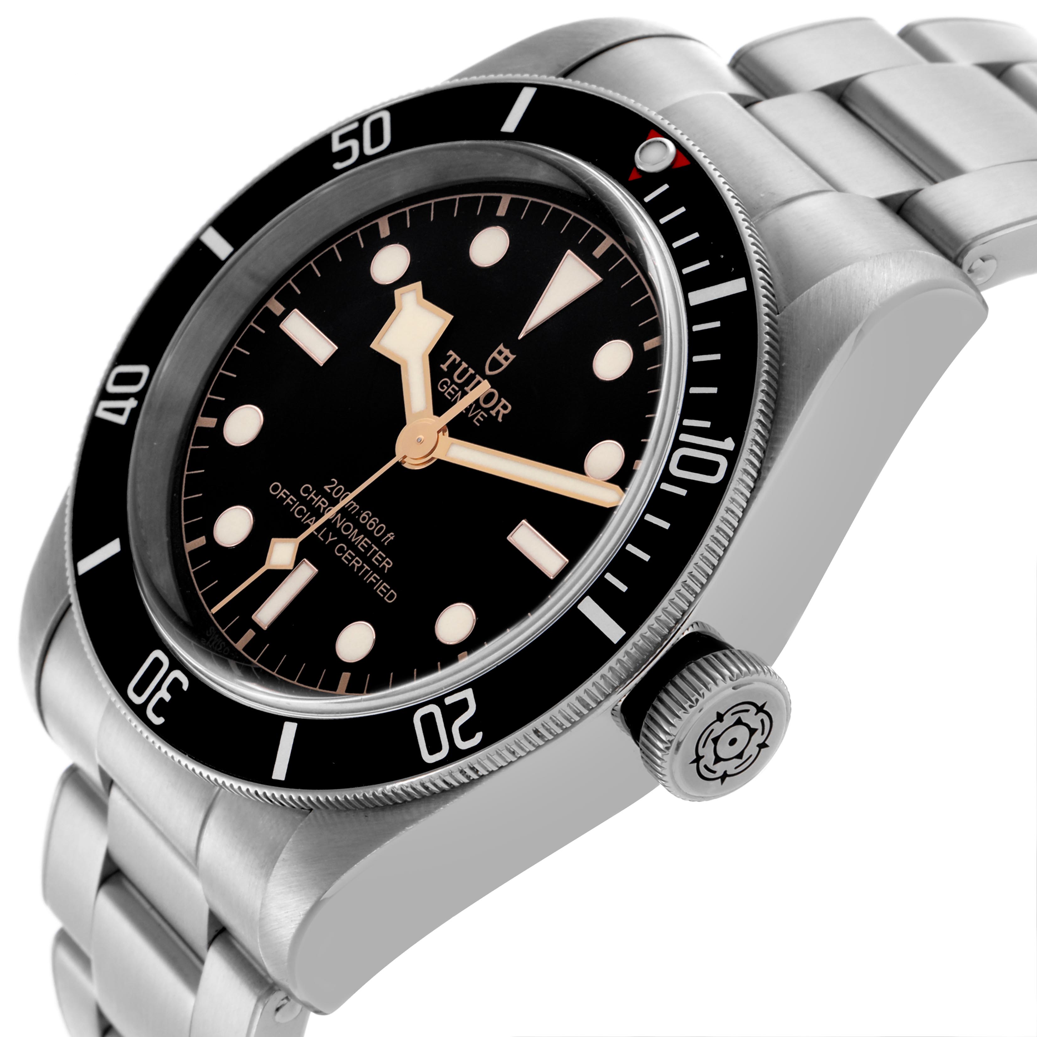 The Tudor Heritage Black Bay 79230N Men's Stainless Steel Black Dial 79230N Men's Stainless Steel Black Dial watch is shown at an angle highlighting the dial, bezel, crown, and metal bracelet.