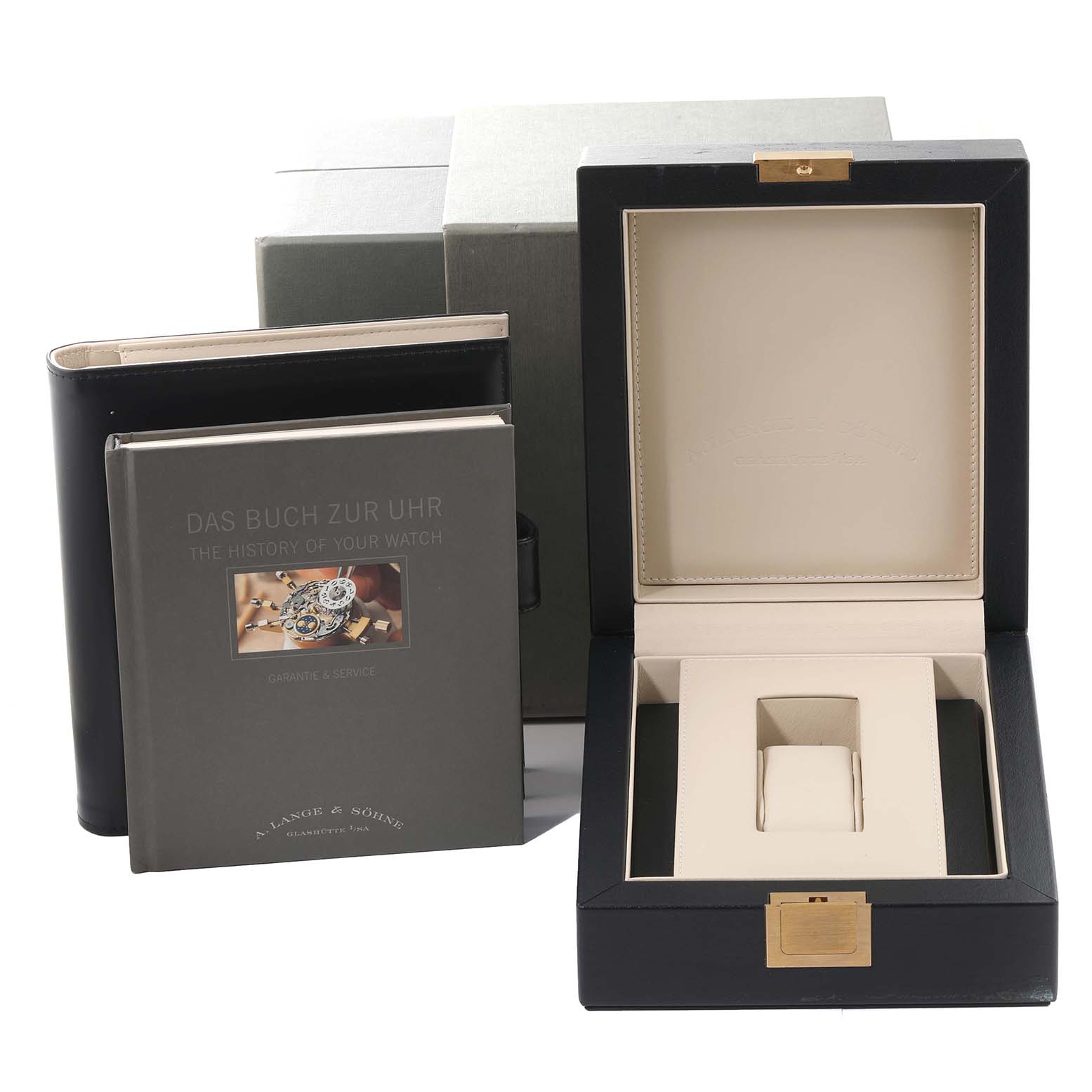 The image shows the packaging and accessories of the A. Lange & Sohne 1815 watch, including a watch box and a booklet.