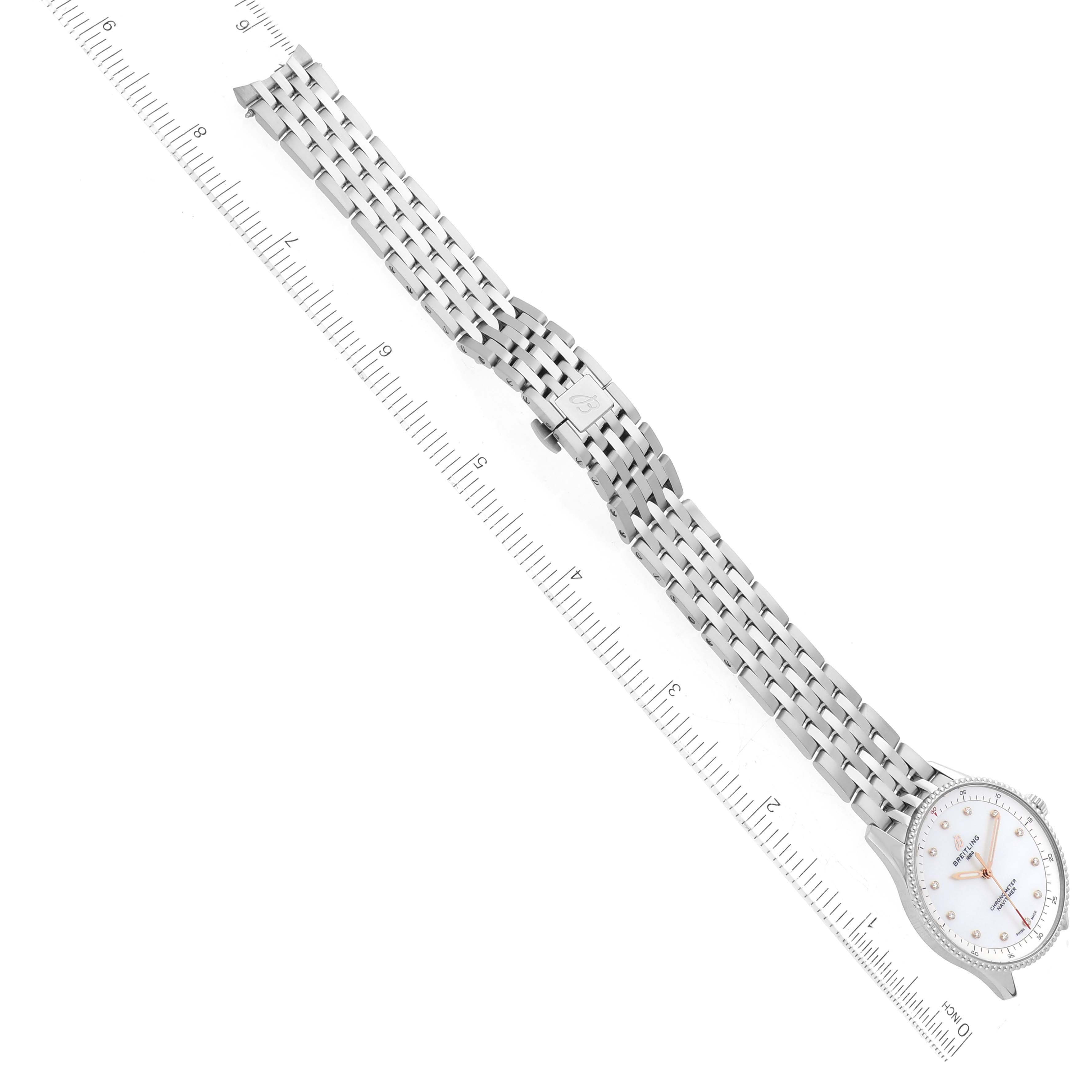 The image shows a top-down view of the Breitling A77320E61A2A1 Women's Stainless Steel Mother of Pearl Dial A77320E61A2A1 Women's Stainless Steel Mother of Pearl Dial Navitimer 32 Mother of Pearl Diamond Dial Steel Ladies Watch A77320 alongside a ruler.