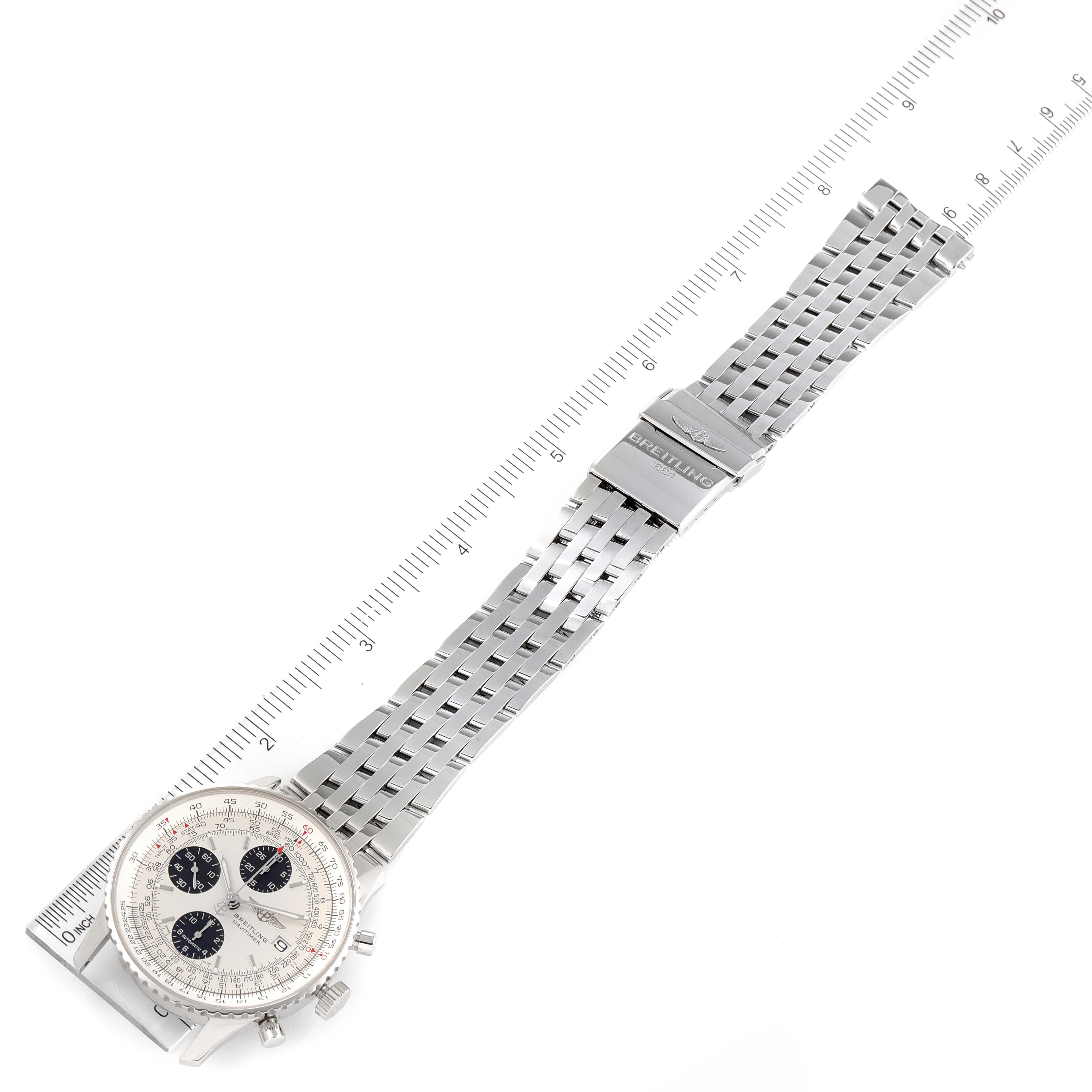 This image shows a top view of a Breitling Navitimer A13324 Men's Stainless Steel Silver Dial A13324 Men's Stainless Steel Silver Dial watch, focusing on the dial, bracelet, and clasp with a measurement ruler beside it.