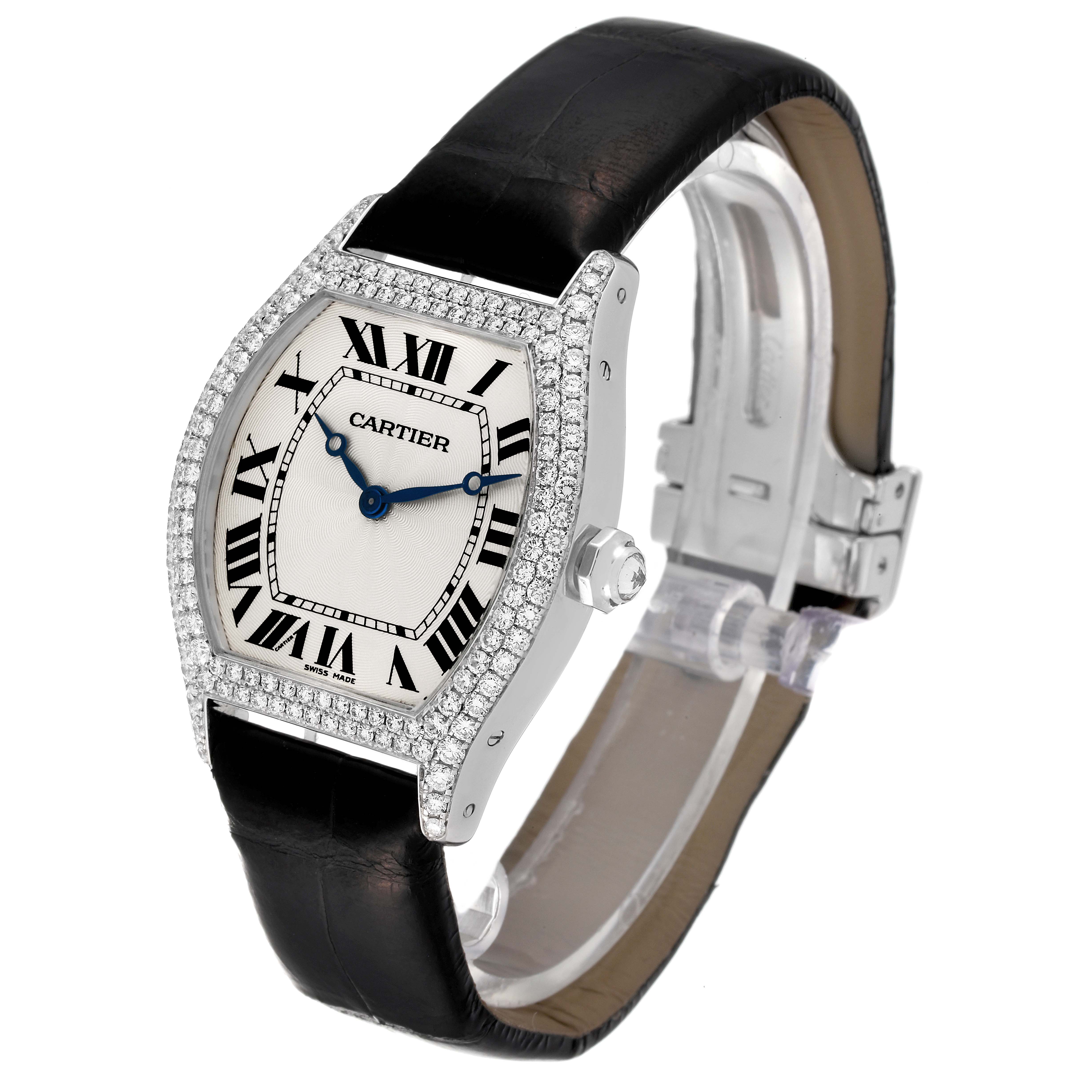 The Cartier Tortue WA504351 Men's White Gold Silver Dial WA504351 Men's White Gold Silver Dial watch is shown from a front angle, displaying its face, Roman numerals, diamond bezel, and black strap.
