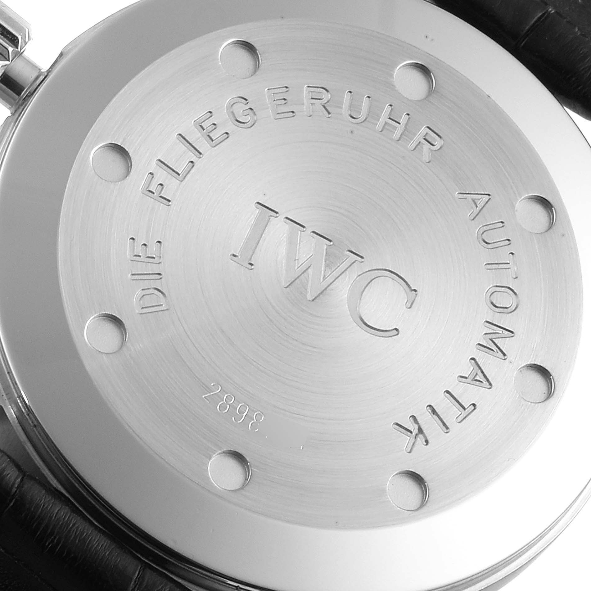 This image shows the back casing of an IWC Pilot IW325301 Men's Stainless Steel Black Dial IW325301 Men's Stainless Steel Black Dial watch, featuring engraved text and screws.