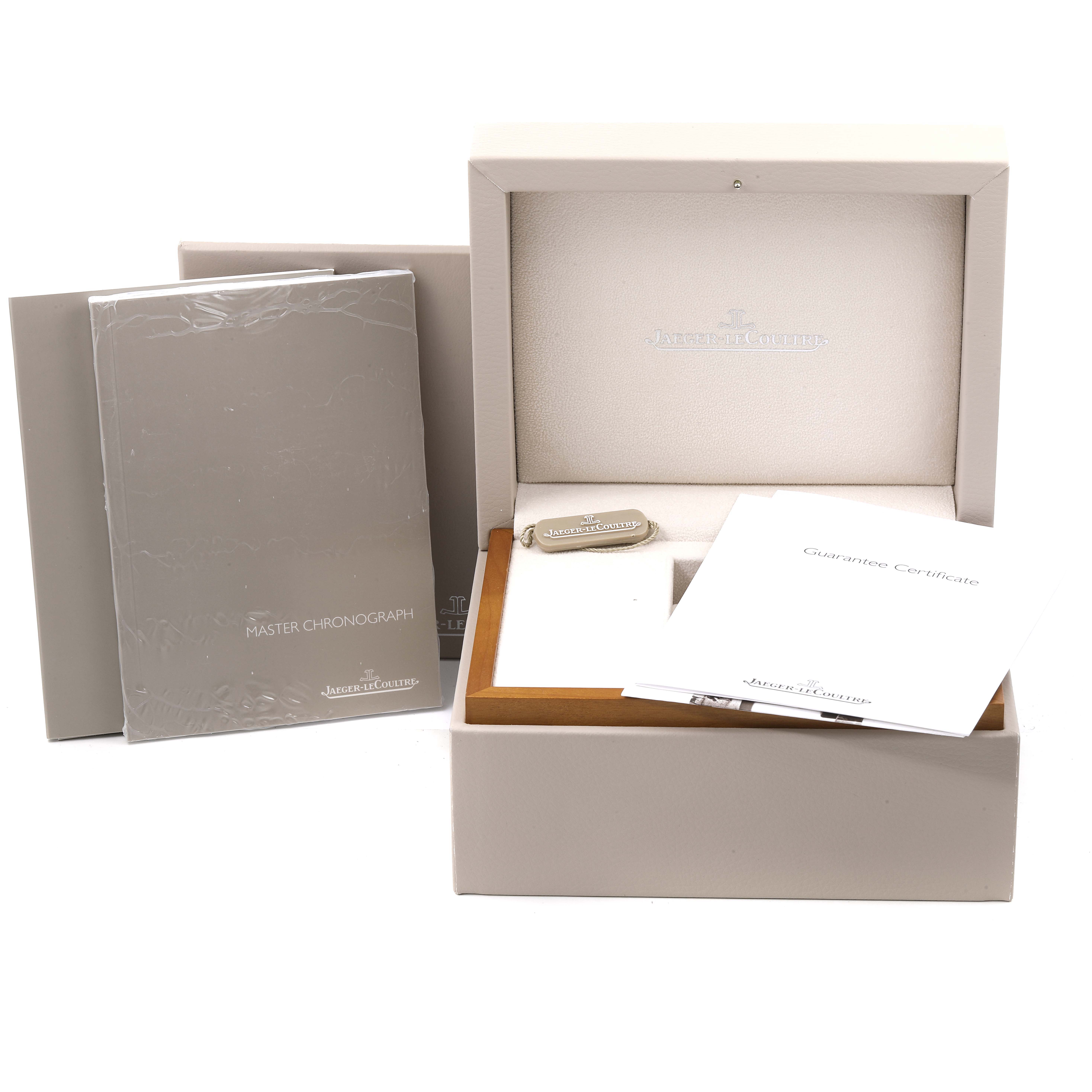 The image shows the packaging, manuals, and guarantee certificate for a Jaeger LeCoultre Master Q1538470 Men's Stainless Steel Black Dial Q1538470 Men's Stainless Steel Black Dial model watch.