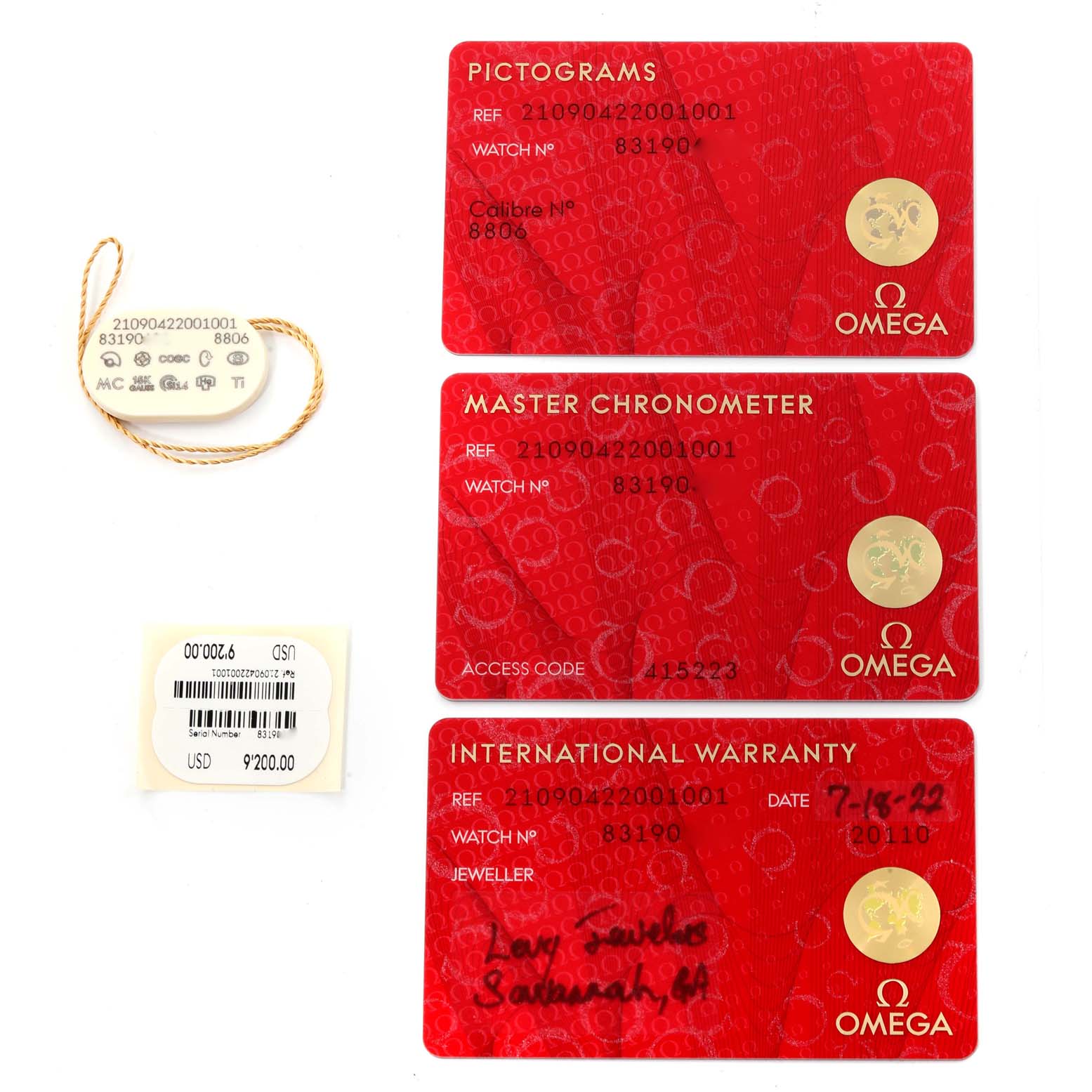 The image shows the warranty card, chronometer card, pictogram card, price tag, and barcode tag for an Omega Seamaster 210.90.42.20.01.001 Men's Titanium Brown Dial 210.90.42.20.01.001 Men's Titanium Brown Dial watch.