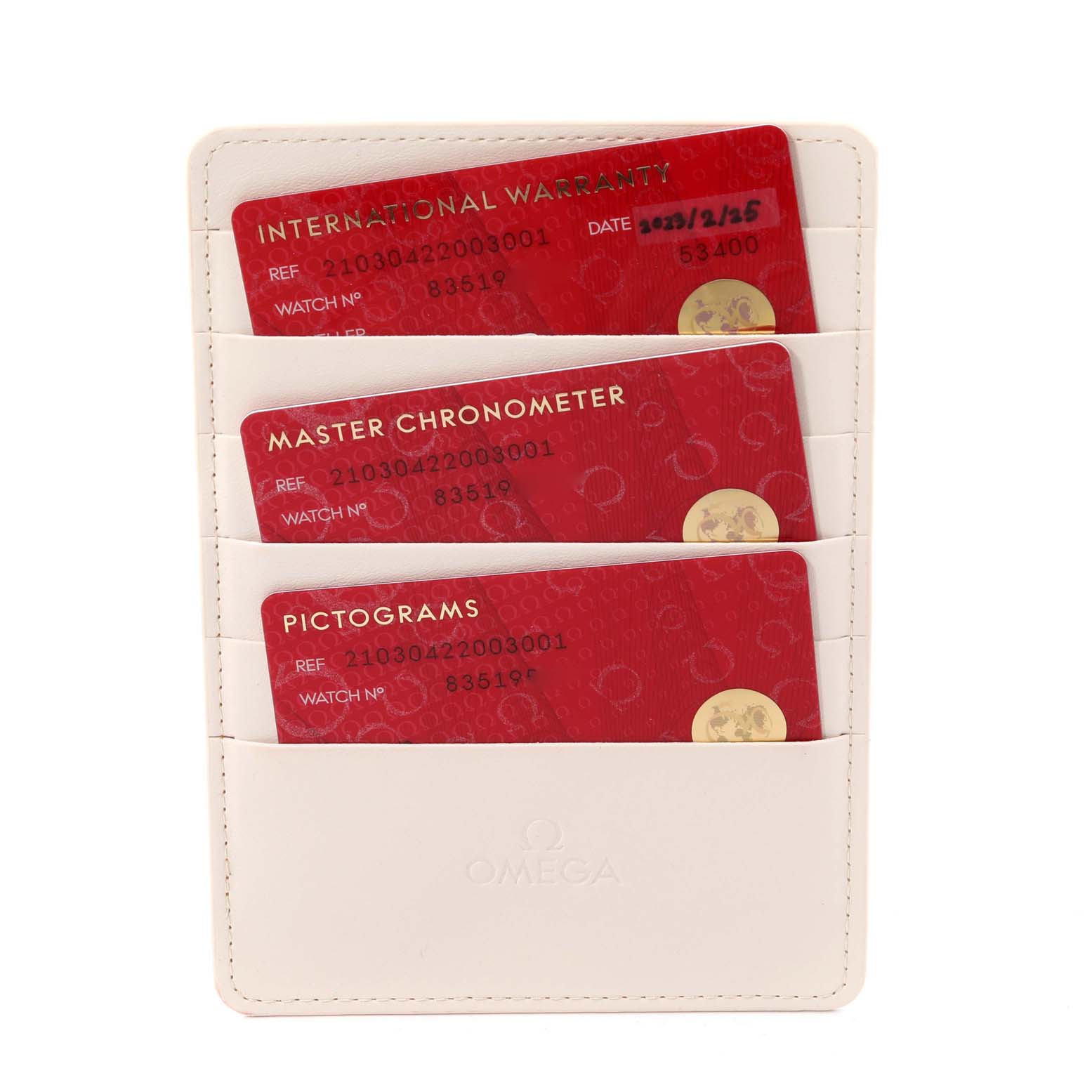 The image shows a white Omega holder containing three red cards for the Omega Seamaster 210.30.42.20.03.001 Men's Stainless Steel Blue Dial 210.30.42.20.03.001 Men's Stainless Steel Blue Dial model: Warranty, Master Chronometer, and Pictograms.