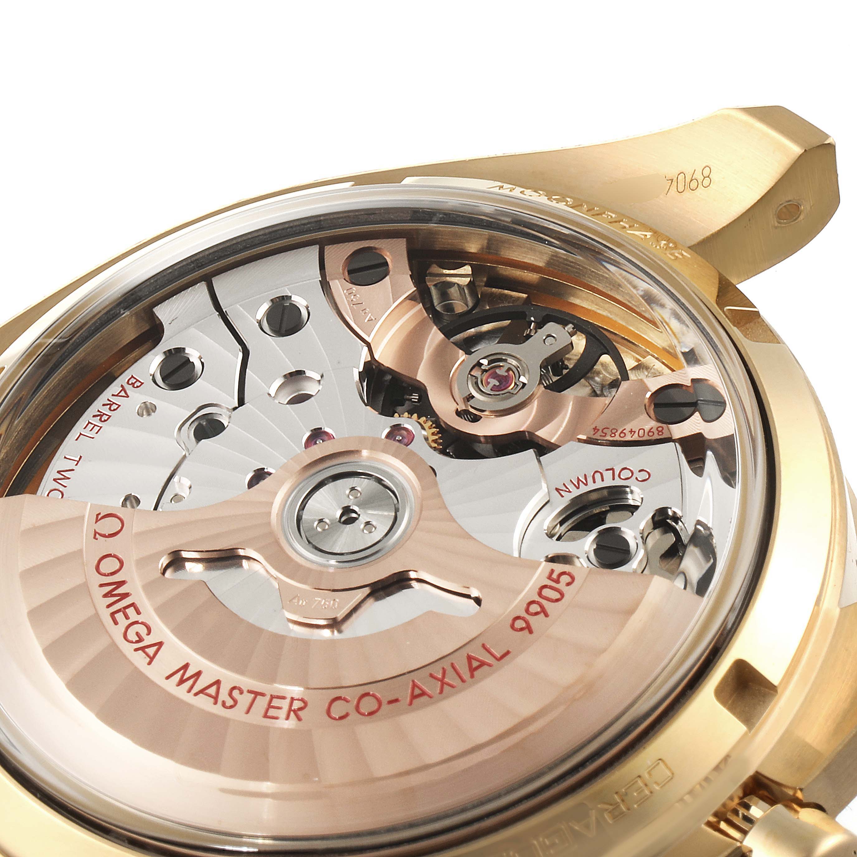 This image shows the backside of an Omega Speedmaster 304.63.44.52.02.001  Men's Yellow Gold Silver Dial 304.63.44.52.02.001  Men's Yellow Gold Silver Dial, highlighting its intricate movement and "Master Co-Axial 9905" mechanism.