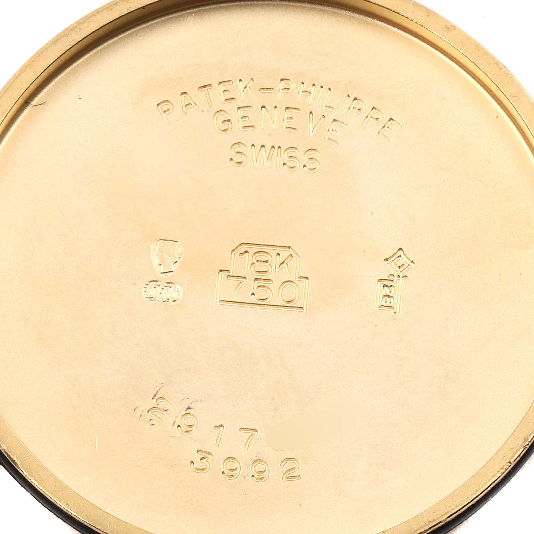 The image shows the inner side of the case back of a Patek Philippe Calatrava 3992 Men's Yellow Gold White Dial 3992 Men's Yellow Gold White Dial watch, featuring engravings.