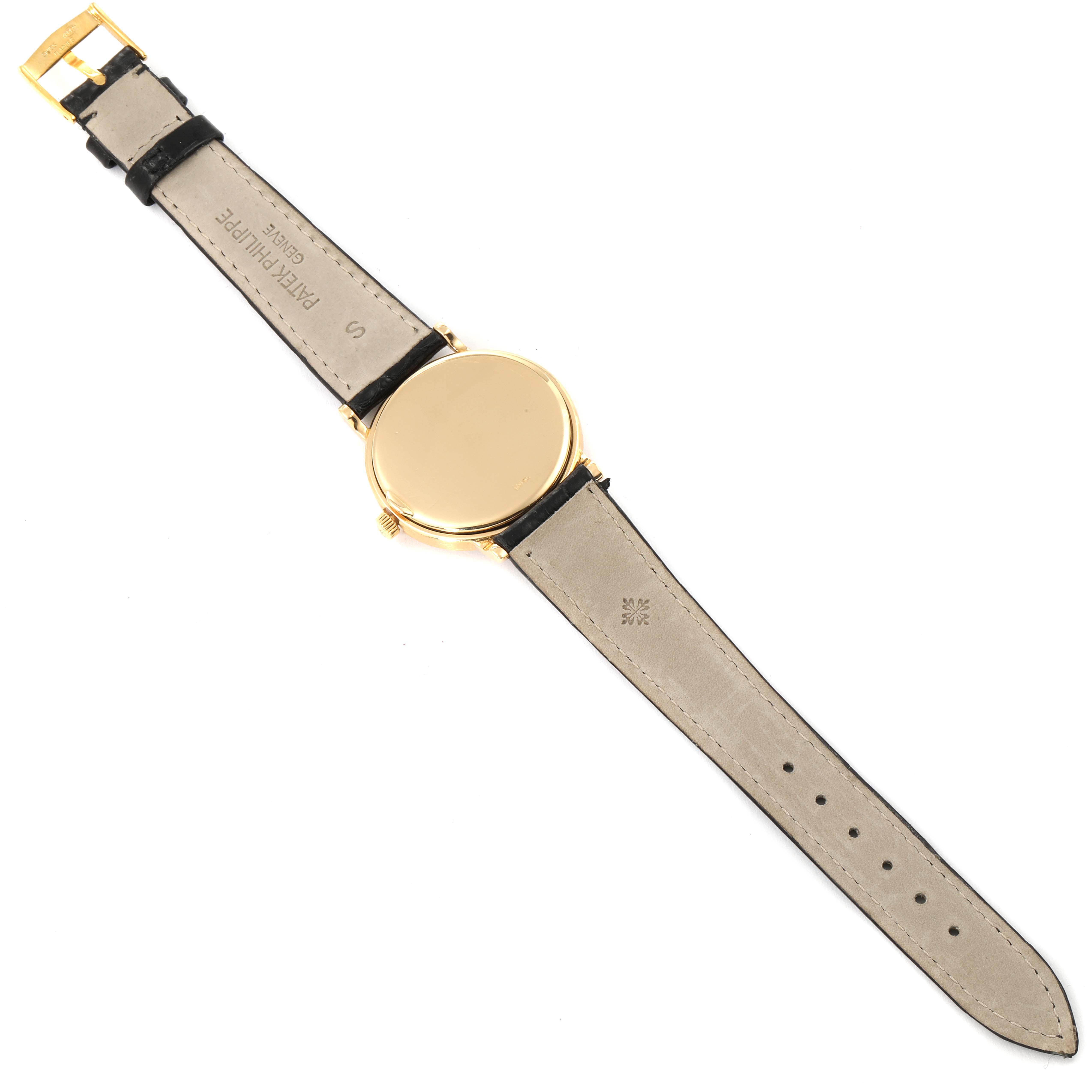 The image shows the back of a Patek Philippe Calatrava 3992 Men's Yellow Gold White Dial 3992 Men's Yellow Gold White Dial watch laid flat, highlighting its leather strap and gold case back.