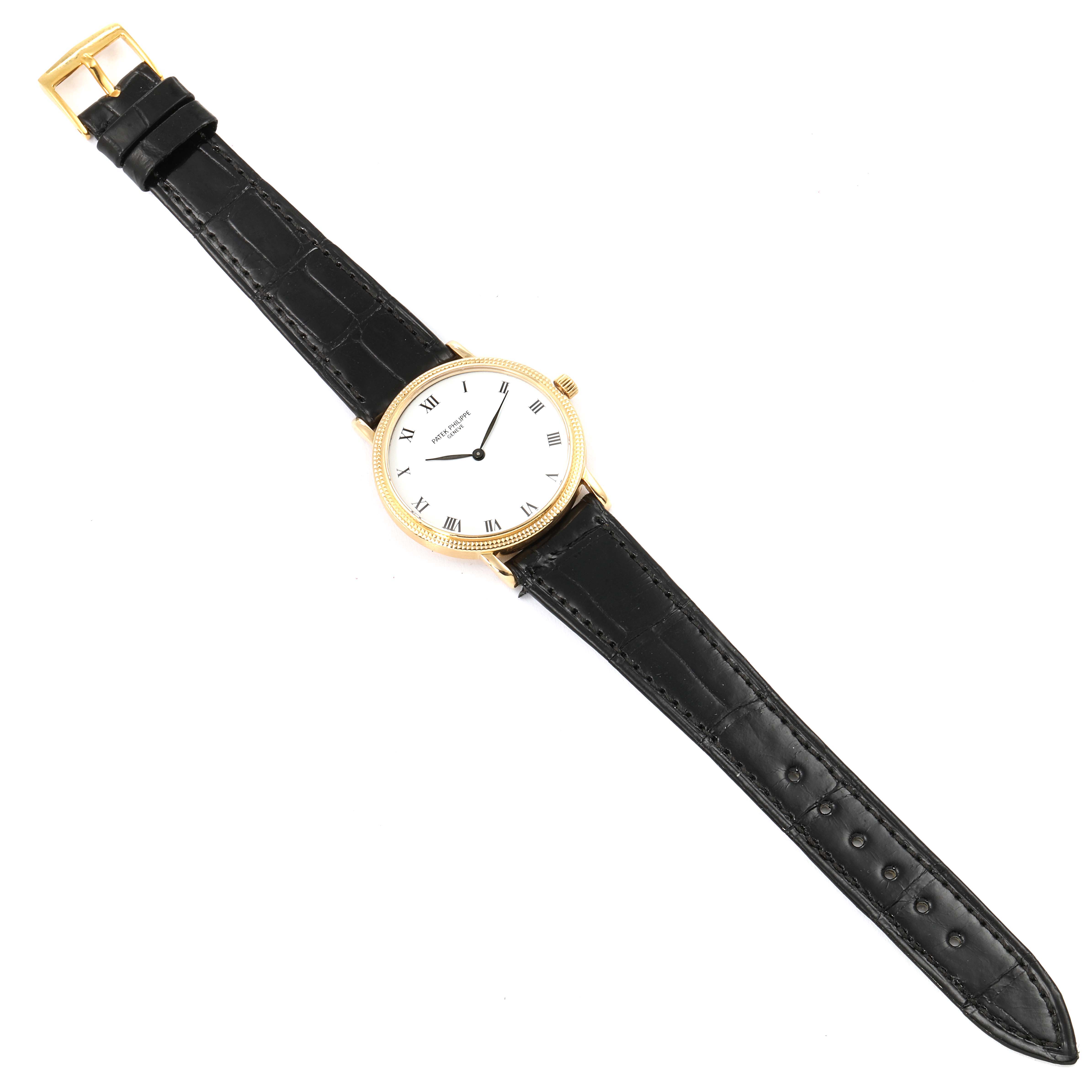 The image shows a Patek Philippe Calatrava 3992 Men's Yellow Gold White Dial 3992 Men's Yellow Gold White Dial wristwatch, featuring a black leather strap and a gold case, viewed from a top-down angle.