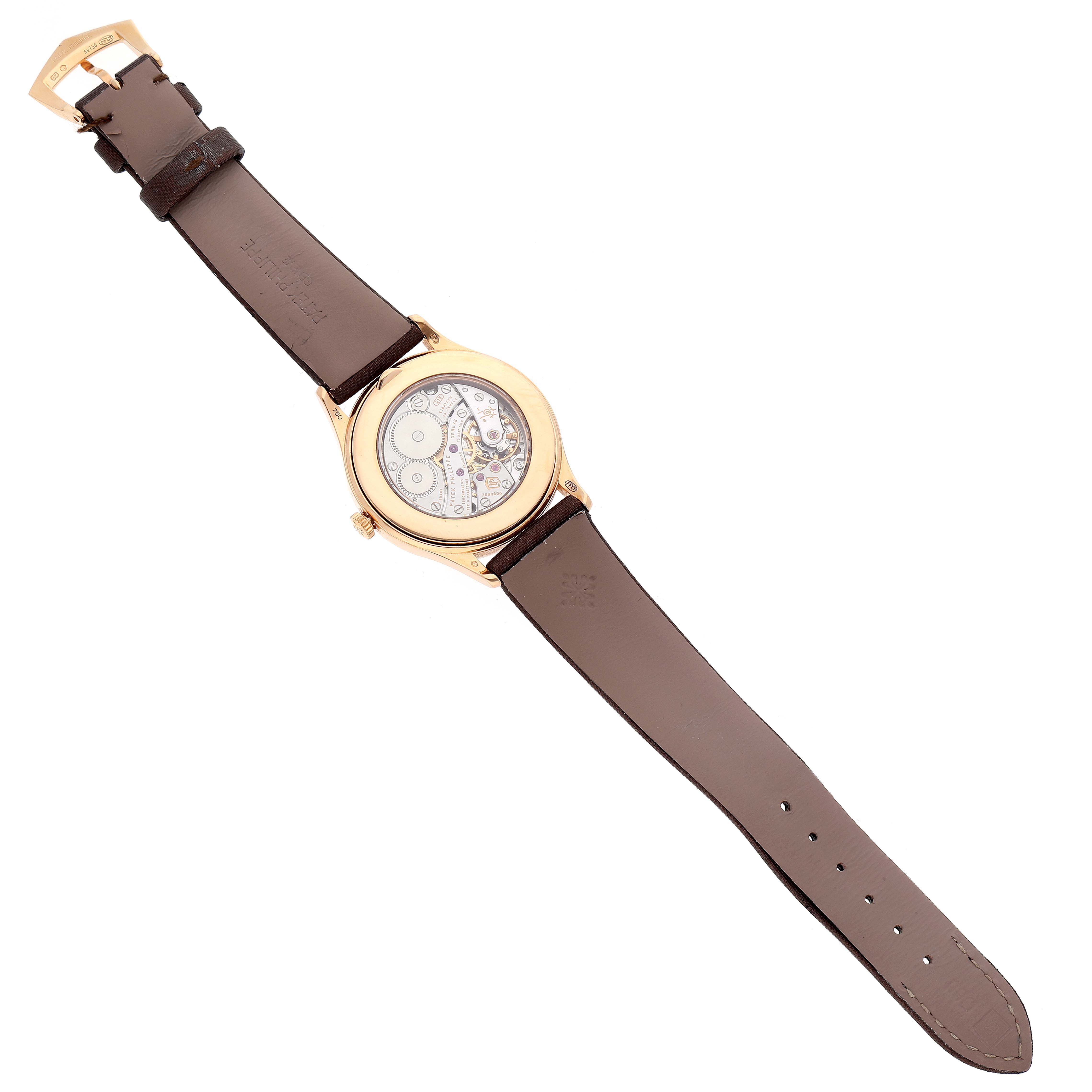 The image shows the back view of the Patek Philippe Calatrava 4897R-001 Women's Rose Gold Brown Dial 4897R-001 Women's Rose Gold Brown Dial watch, highlighting its exposed mechanism and brown leather strap.