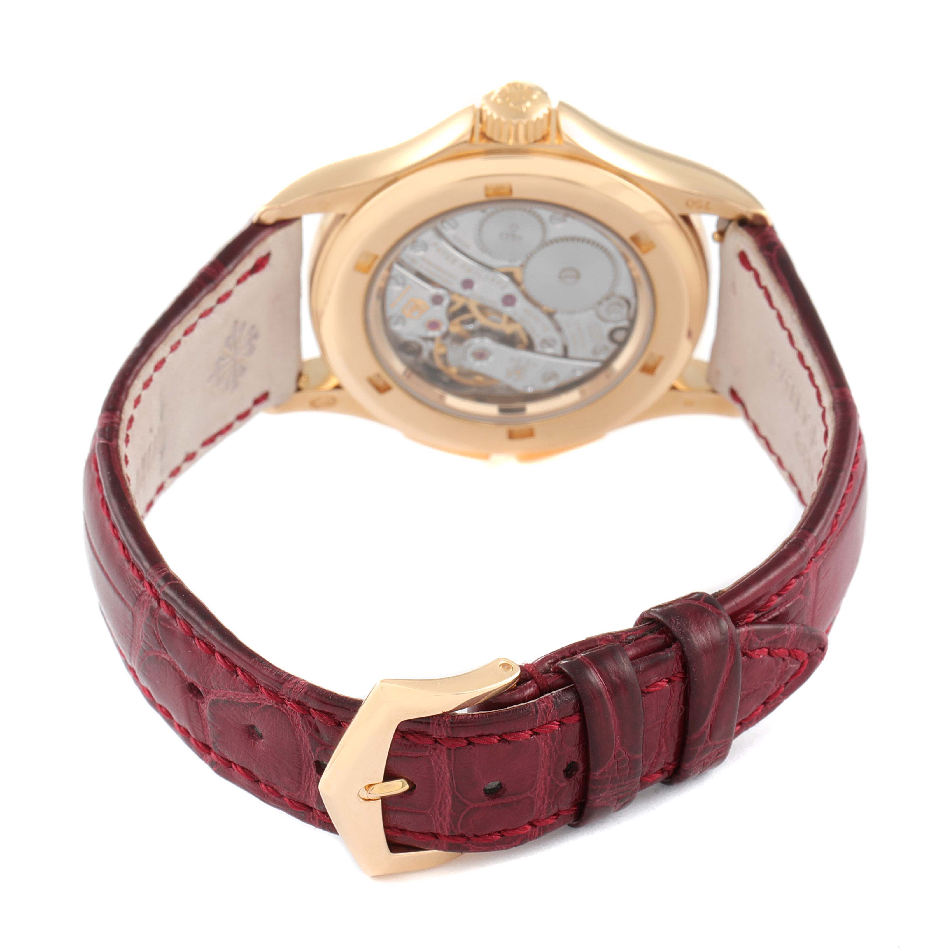 The image shows the back view of a Patek Philippe Calatrava 4934R Women's Rose Gold Mother of Pearl Dial 4934R Women's Rose Gold Mother of Pearl Dial watch with a gold case and red leather strap.