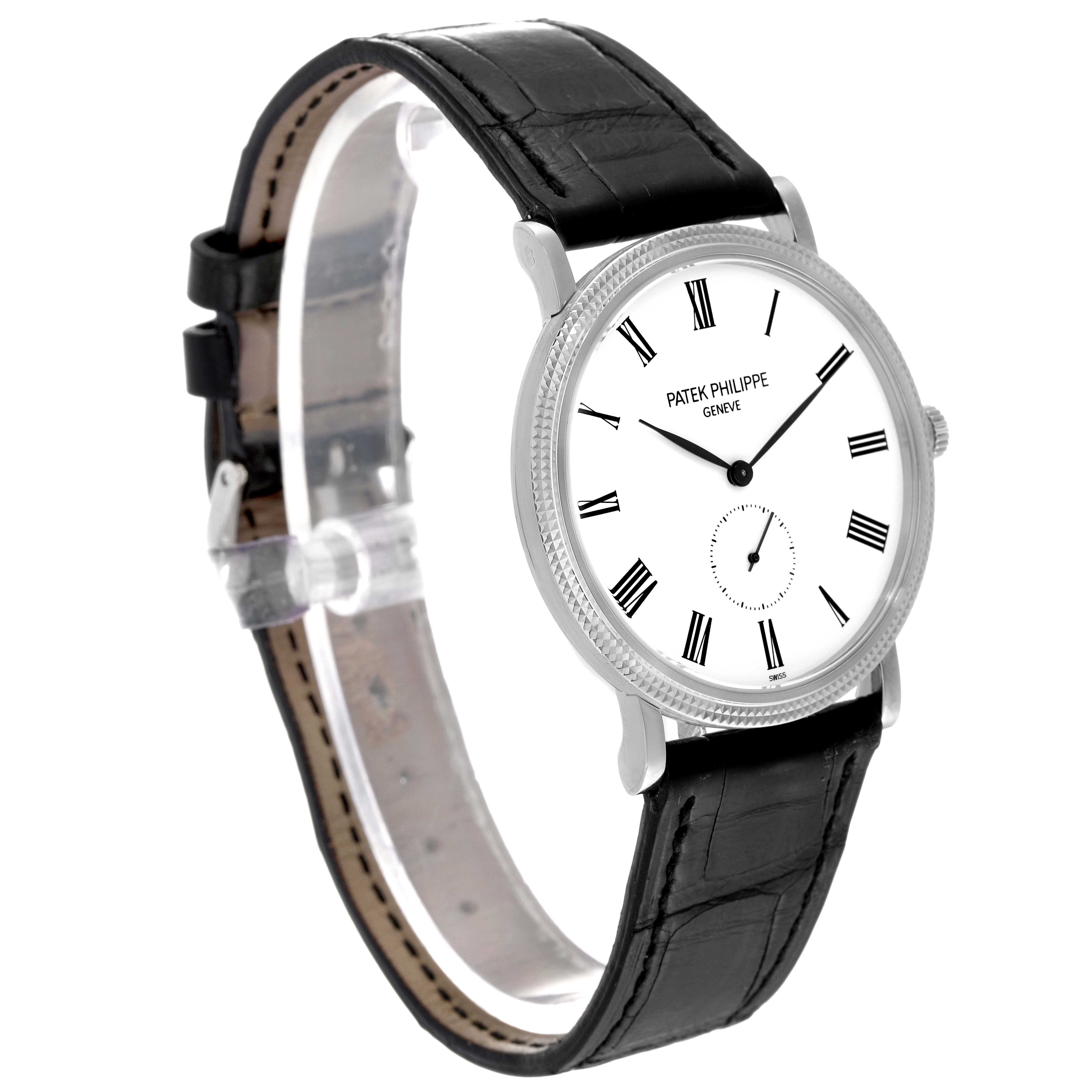This image shows a Patek Philippe Calatrava 5119G-001 Men
s White Gold White Dial 5119G-001 Men
s White Gold White Dial model wristwatch from a front-side angle, highlighting its face and black leather strap.
