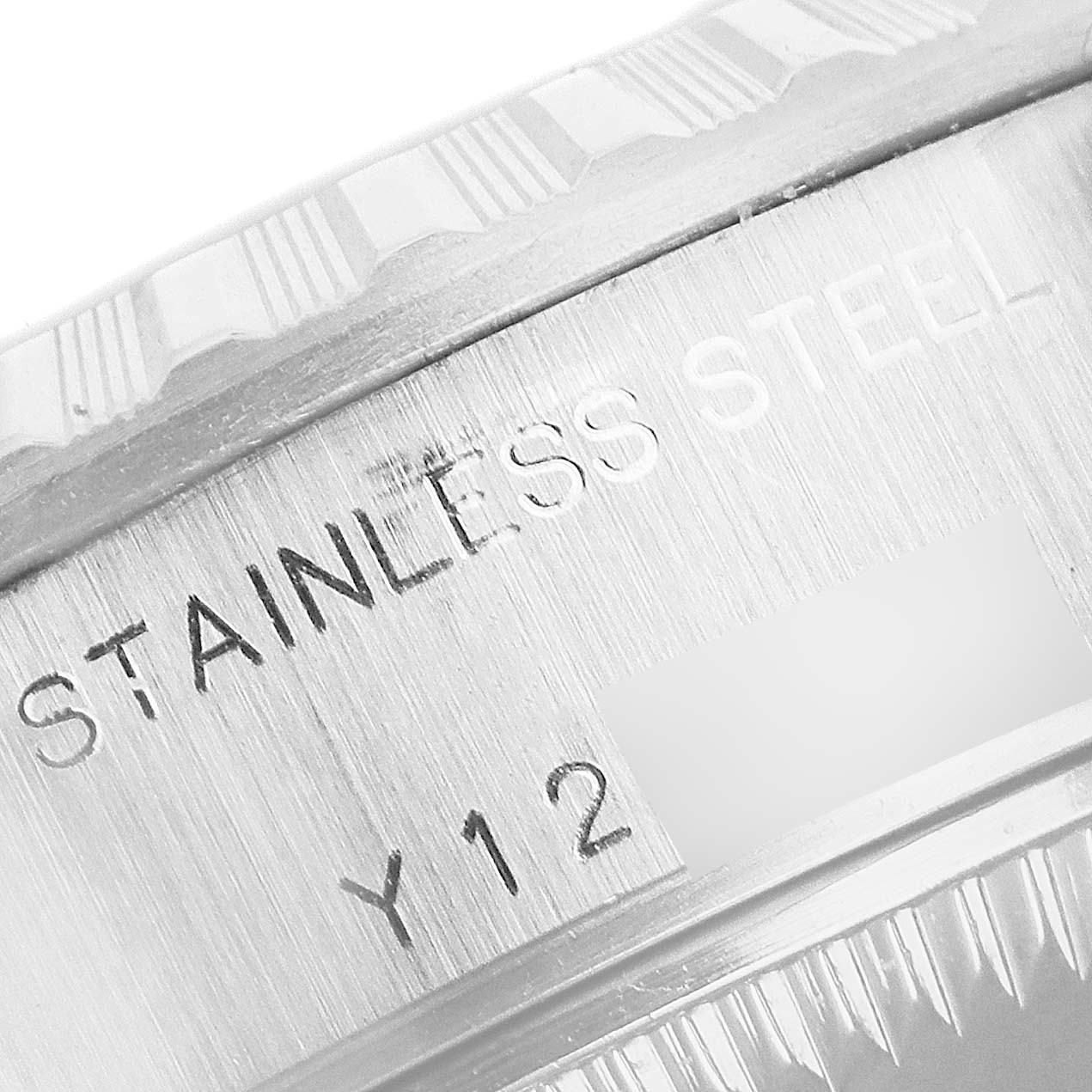 This close-up image of a Rolex Date 79240 Women's Stainless Steel Pink Dial 79240 Women's Stainless Steel Pink Dial watch shows the stainless steel engraving on the side of the case and part of the bezel.