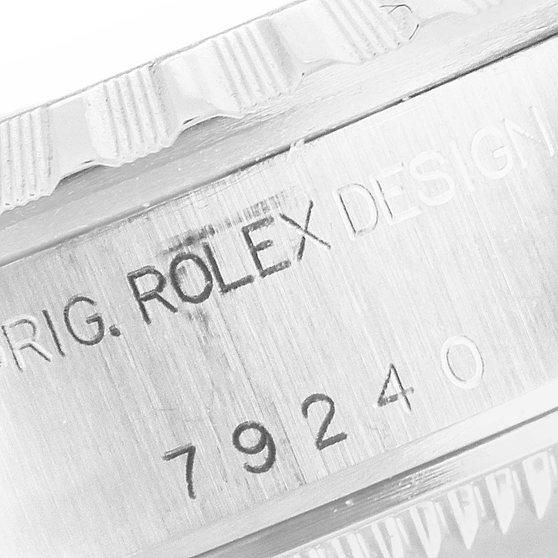 The image shows a close-up view of the engraved side of a Rolex Date 79240 Women's Stainless Steel Pink Dial 79240 Women's Stainless Steel Pink Dial model, highlighting the "ROLEX DESIGN" and serial number.